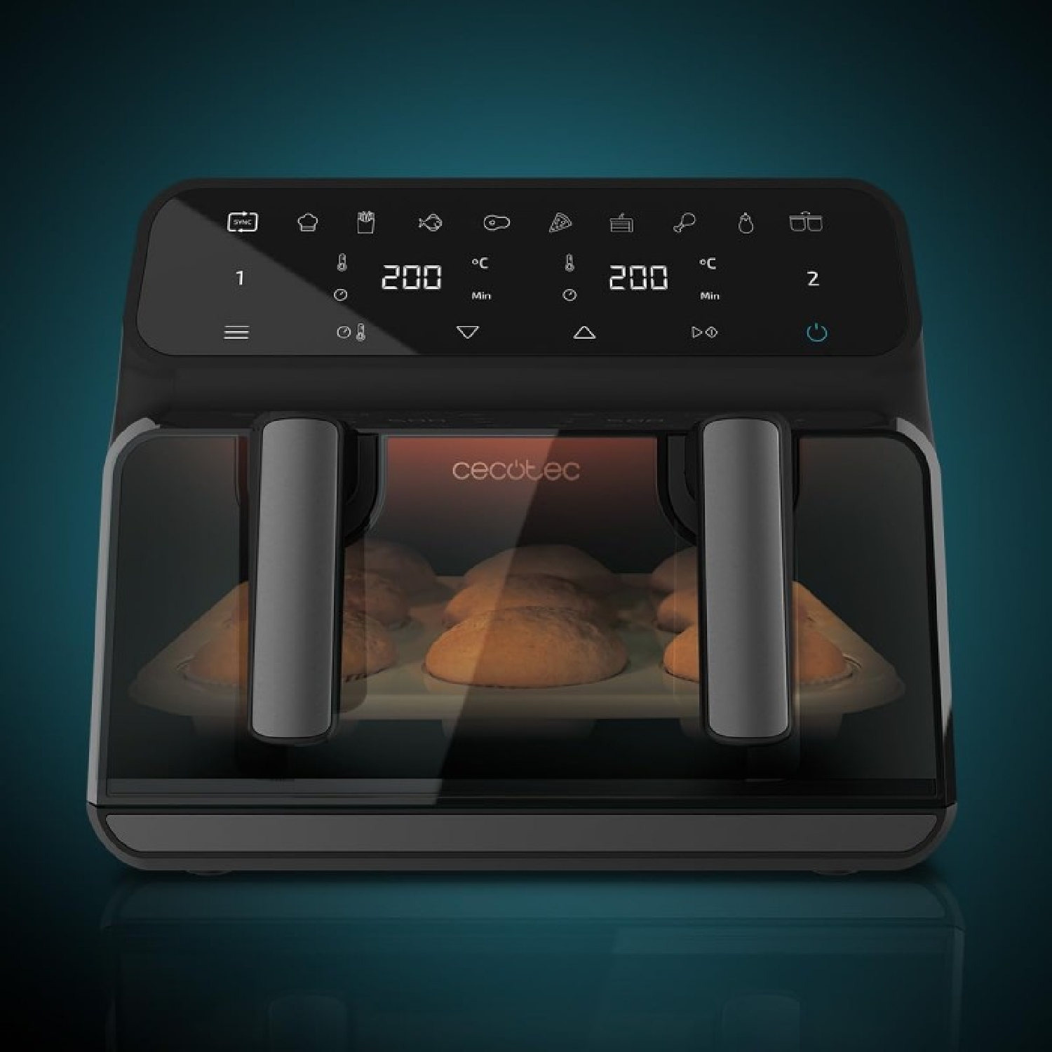 Czarna frytkownica beztłuszczowa z dwoma komorami. Jedzenie widoczne w środku. Panel sterowania na górze.