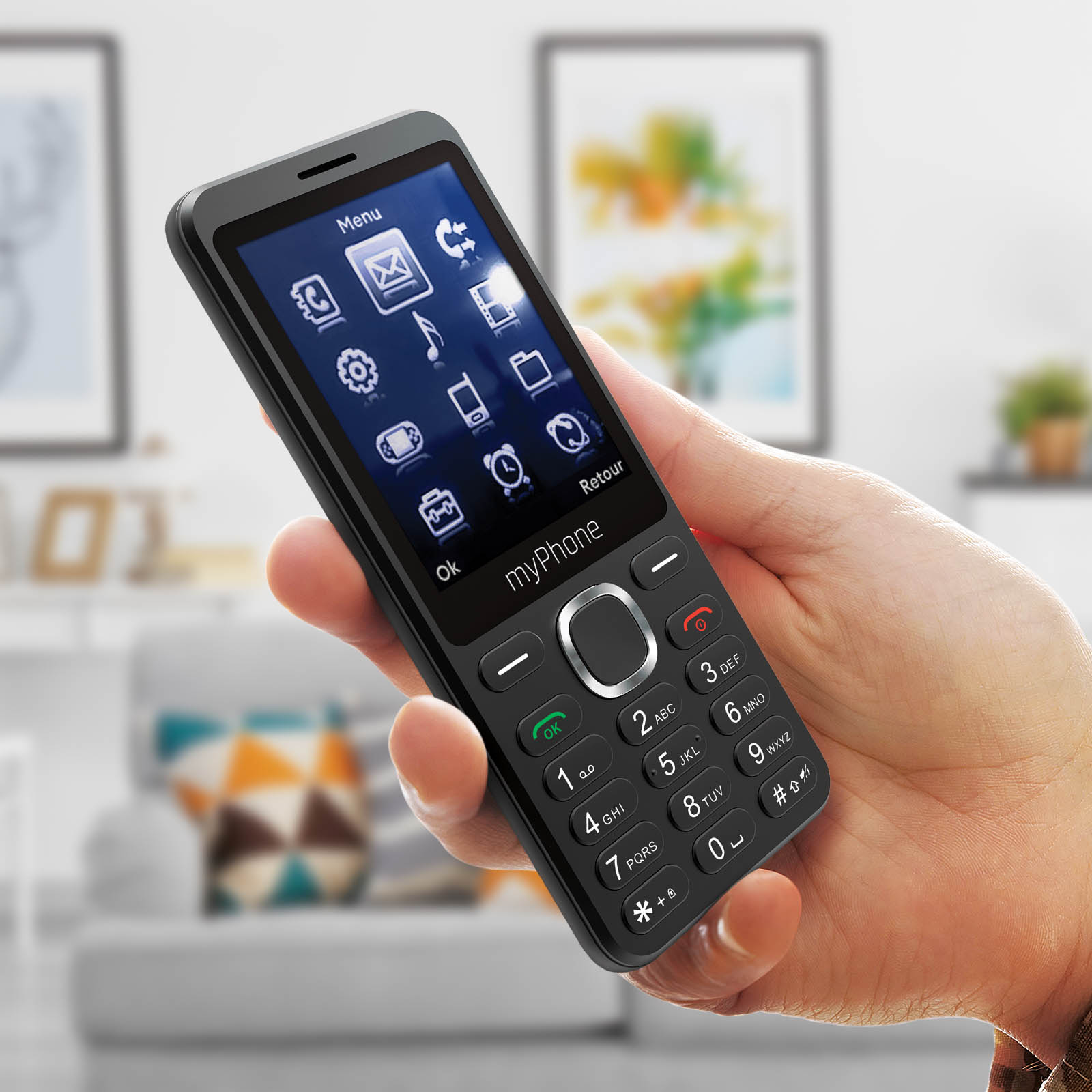 Eine Hand hält ein schwarzes Smartphone mit App-Symbolen auf dem Display.