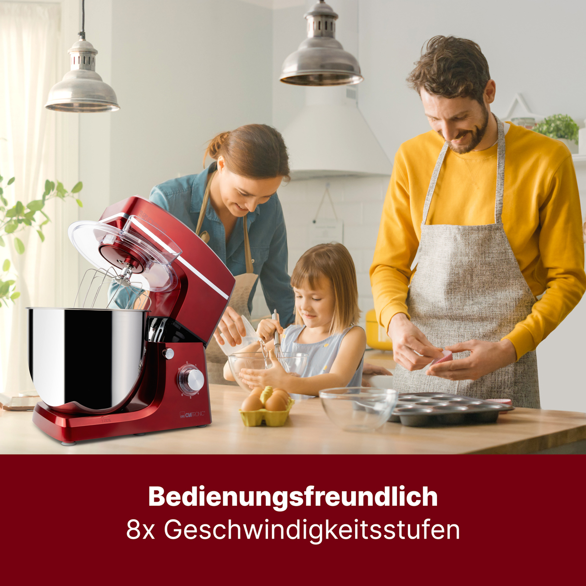 Rodzina w kuchni z czerwonym mikserem, dziewczynka mieszająca i mężczyzna przygotowujący babeczki.