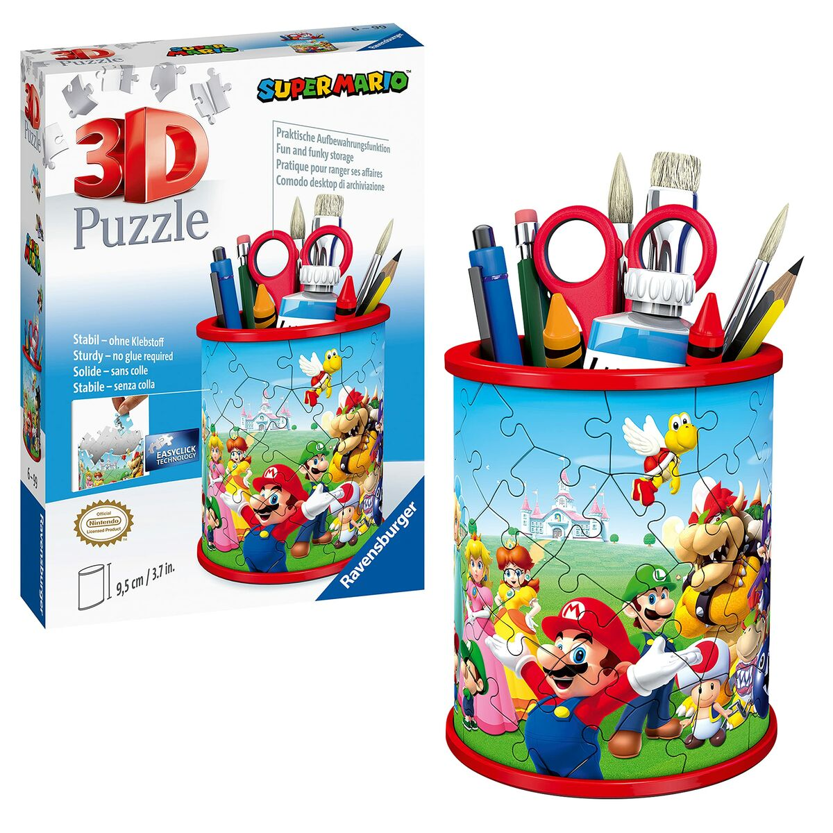 Pudełko z puzzlami 3D z Super Mario. Obok pudełka pokazano gotowy garnek z puzzli z artykułami artystycznymi.