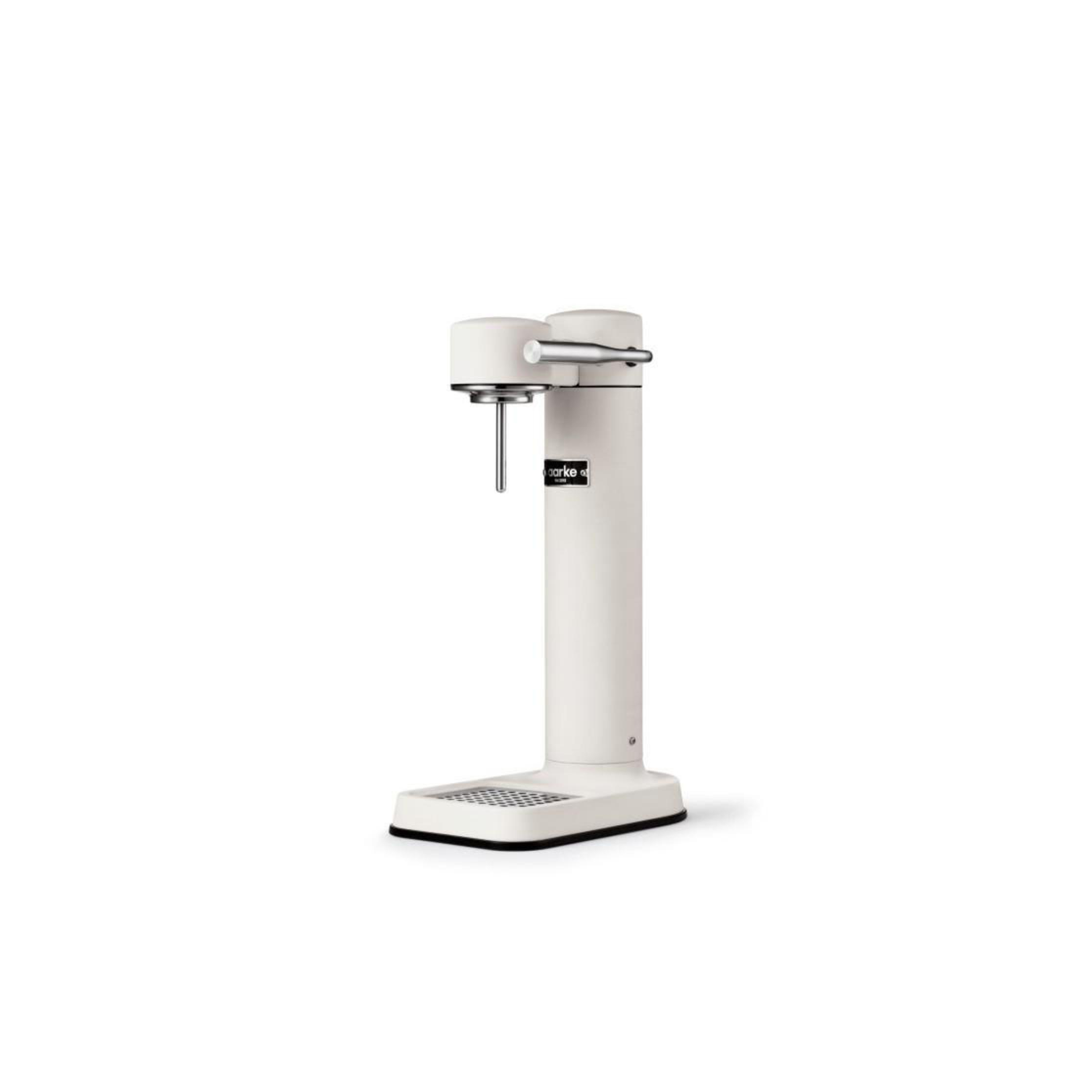 Un apparecchio SodaStream bianco con manico argentato, base nera e la parola 'sparkle'.