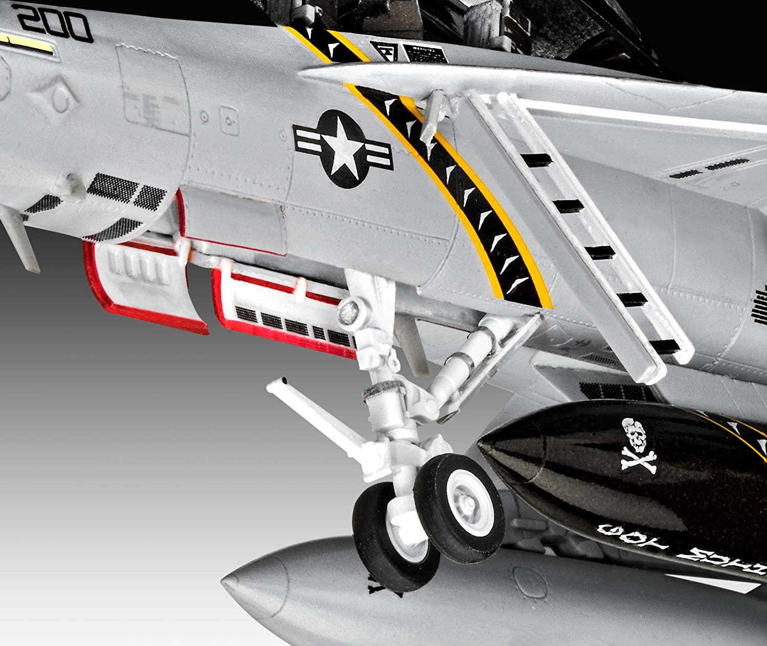 Primo piano del carrello di atterraggio di un aereo modello, con ruote e design nero e giallo sull'ala.