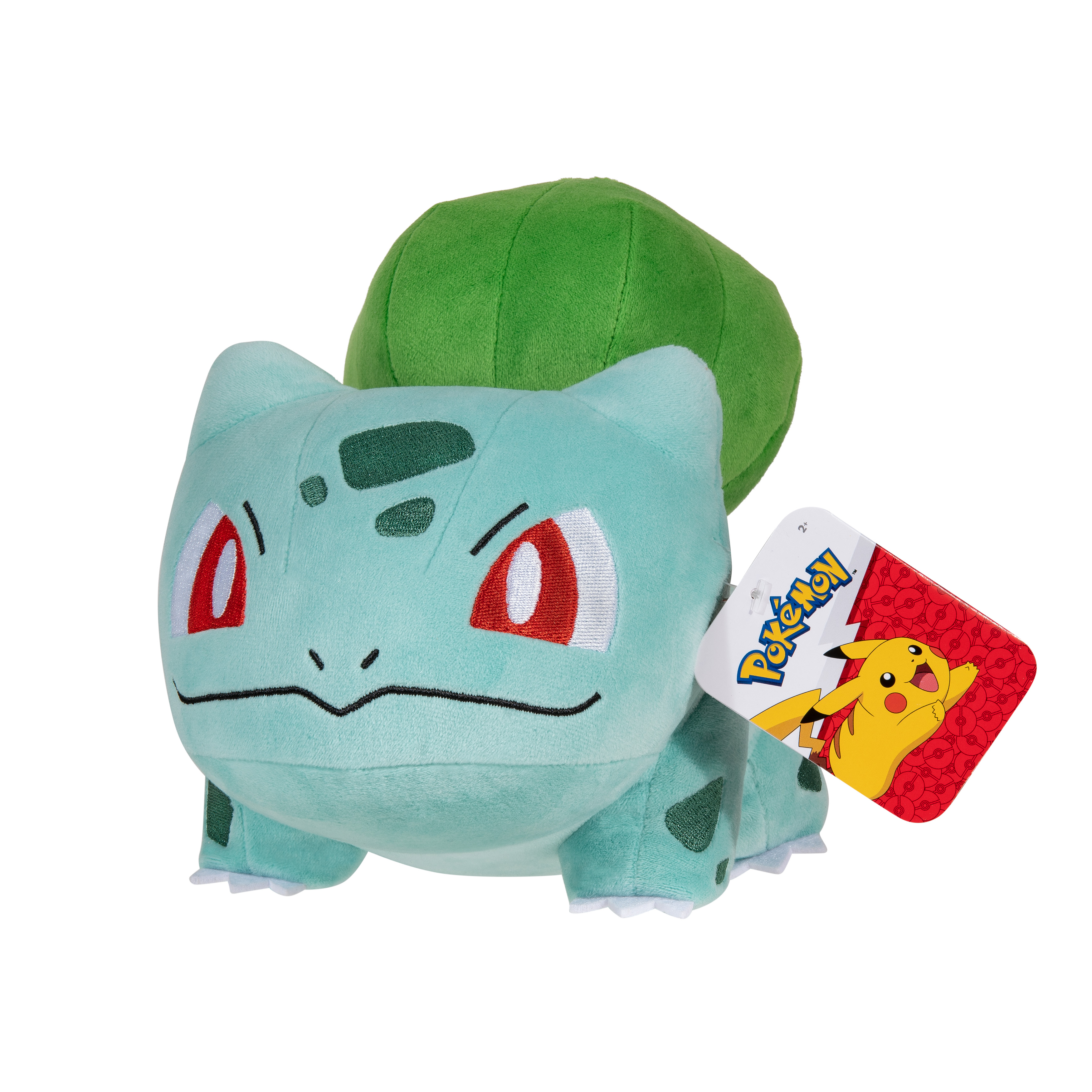Peluche Bulbasaur. Il a la peau verte, des yeux rouges, un bulbe vert sur le dos et une étiquette.