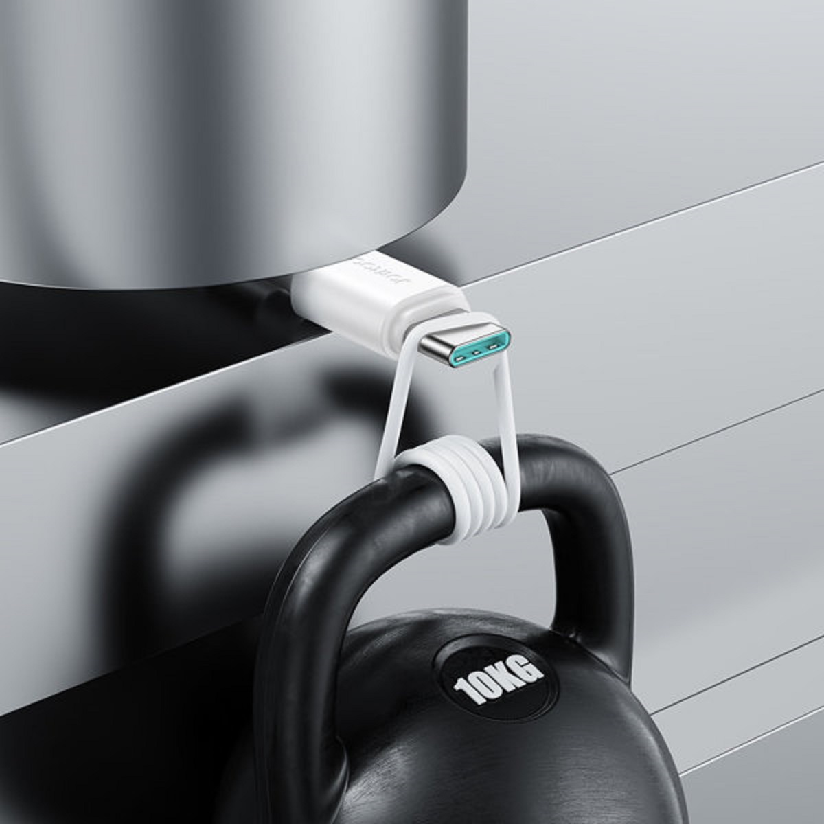 Kabel USB-C podłączony do kettlebell. Kabel jest biały, a kettlebell czarny.