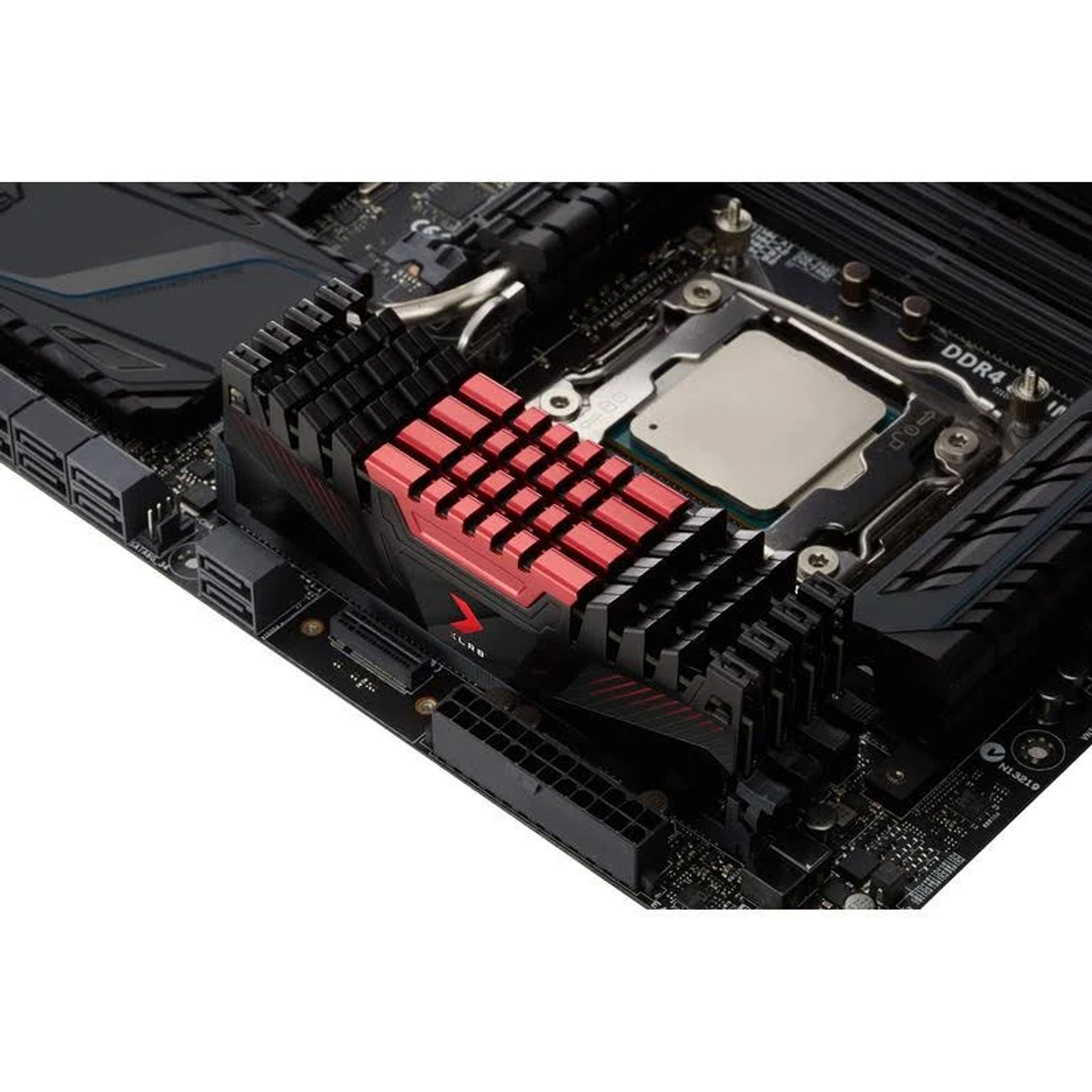 Płyta główna z czerwono-czarnym radiatorem, procesorem i różnymi portami.