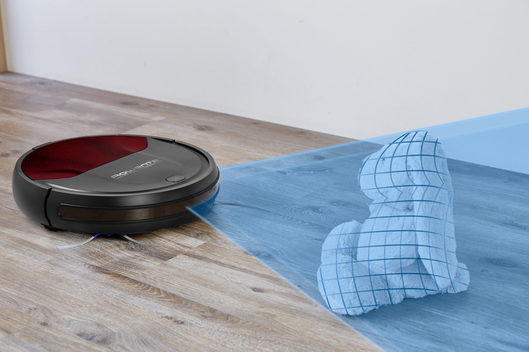 Un robot aspirador limpiando un piso de madera. Un área azul muestra la ruta limpia.