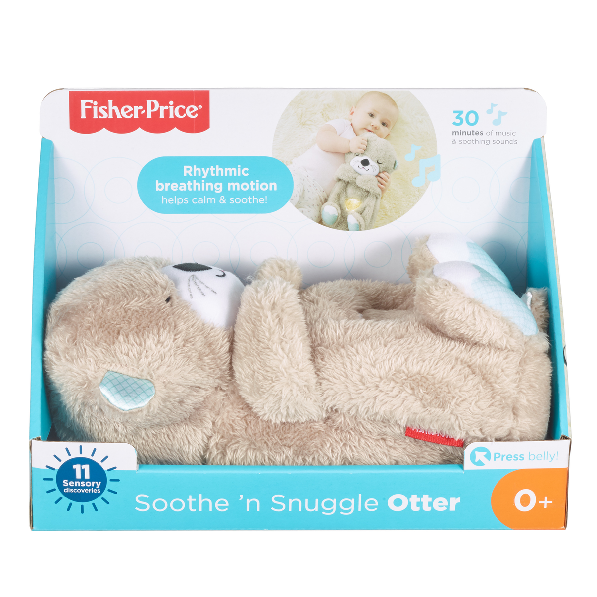 Ein Stoffotter-Spielzeug in einer Box. Die Box hat Text, und ein Baby ist im Hintergrund.