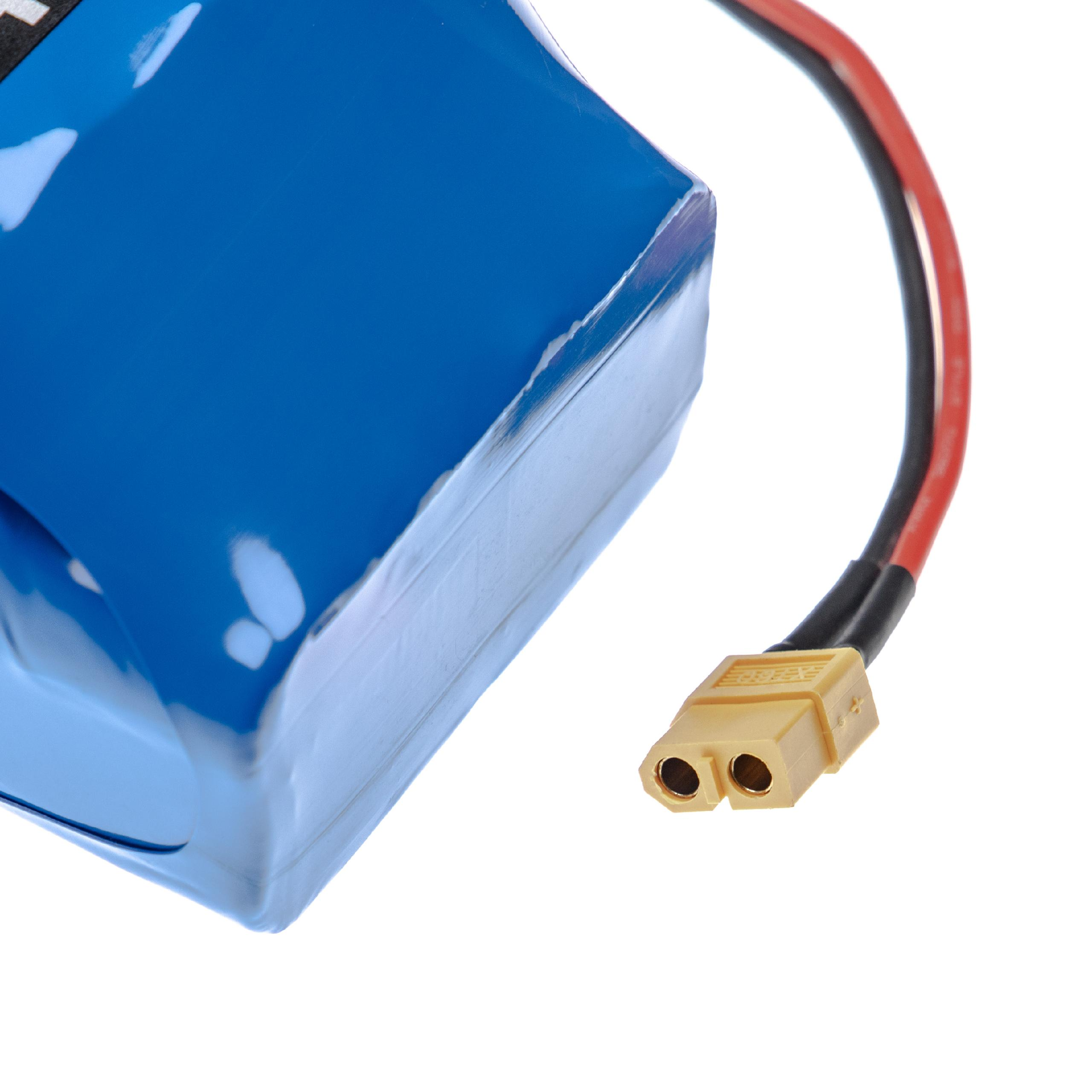 Eine blaue Batterie mit einem gelben Stecker und schwarzen und roten Drähten.