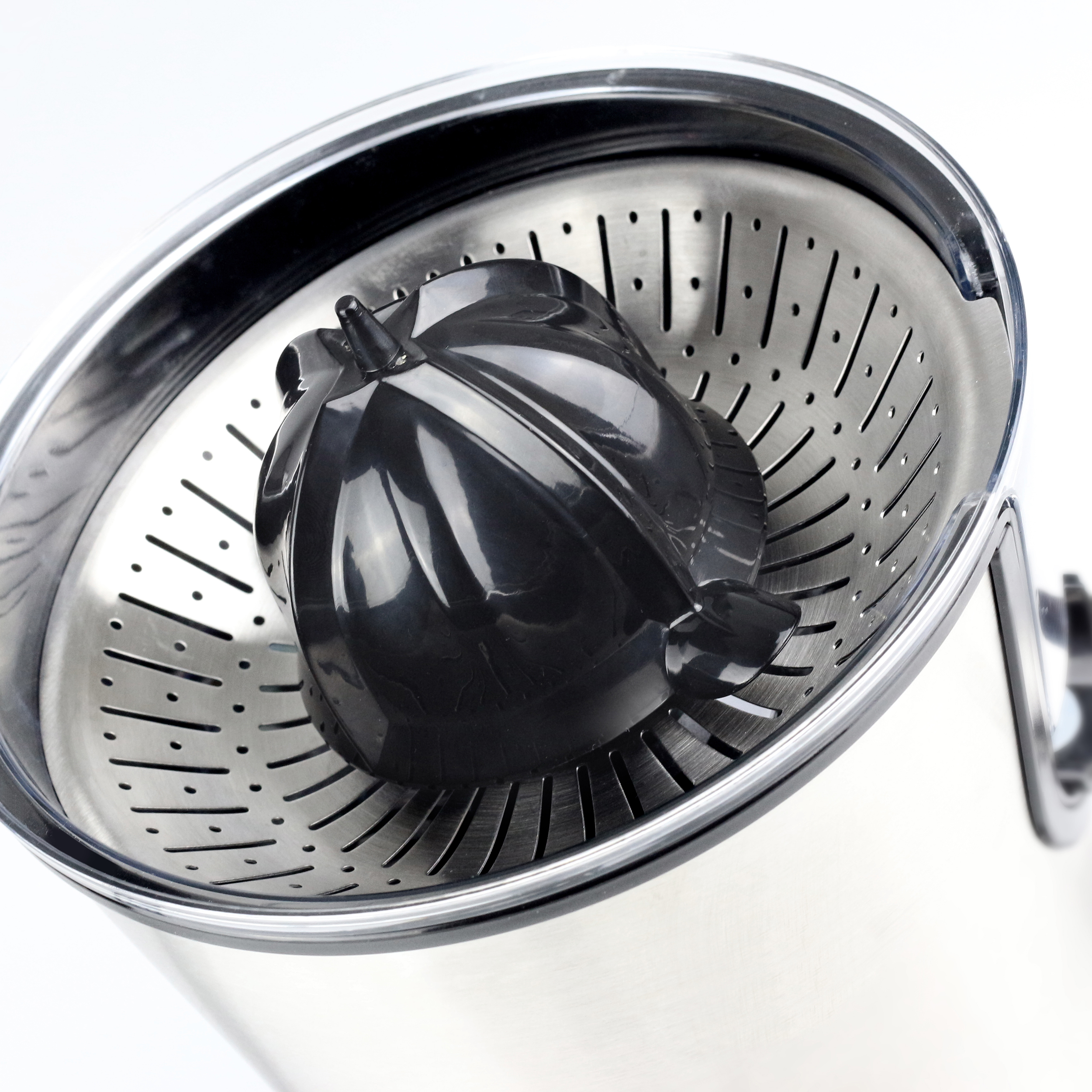 Primo piano dello spremiagrumi con filtro metallico perforato e reamer nero.