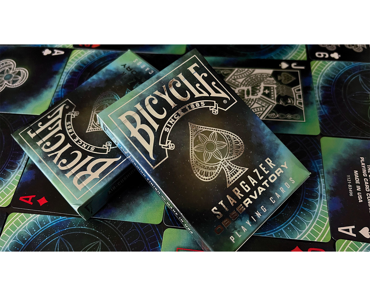 Zwei Bicycle Stargazer Observatory Spielkarten-Decks. Die Karten sind im Hintergrund sichtbar.