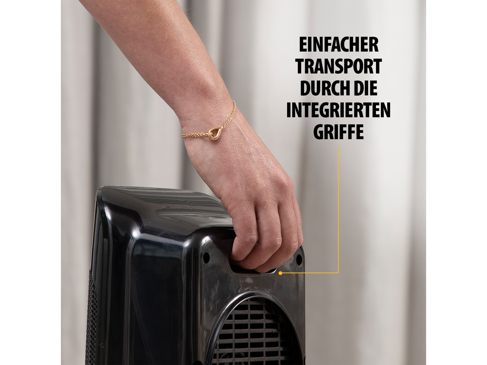 Ręka trzyma czarne urządzenie. Tekst u góry brzmi: „Einfacher Transport durch die integrierten Griffe”.