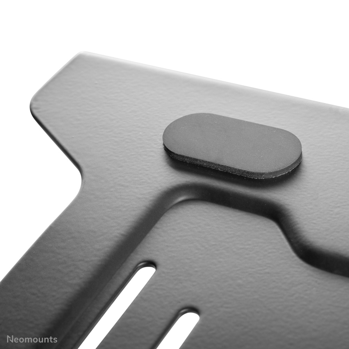 Black metal plate with rubber pad and slots.