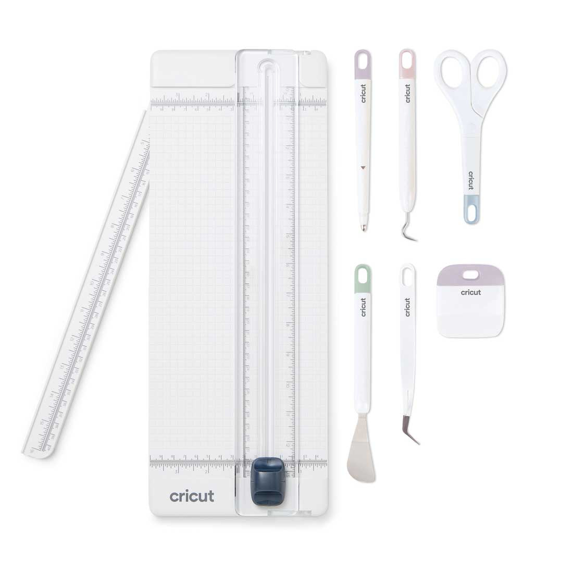 Bastelwerkzeuge: Lineal, Trimmer und verschiedene Cricut-Werkzeuge.