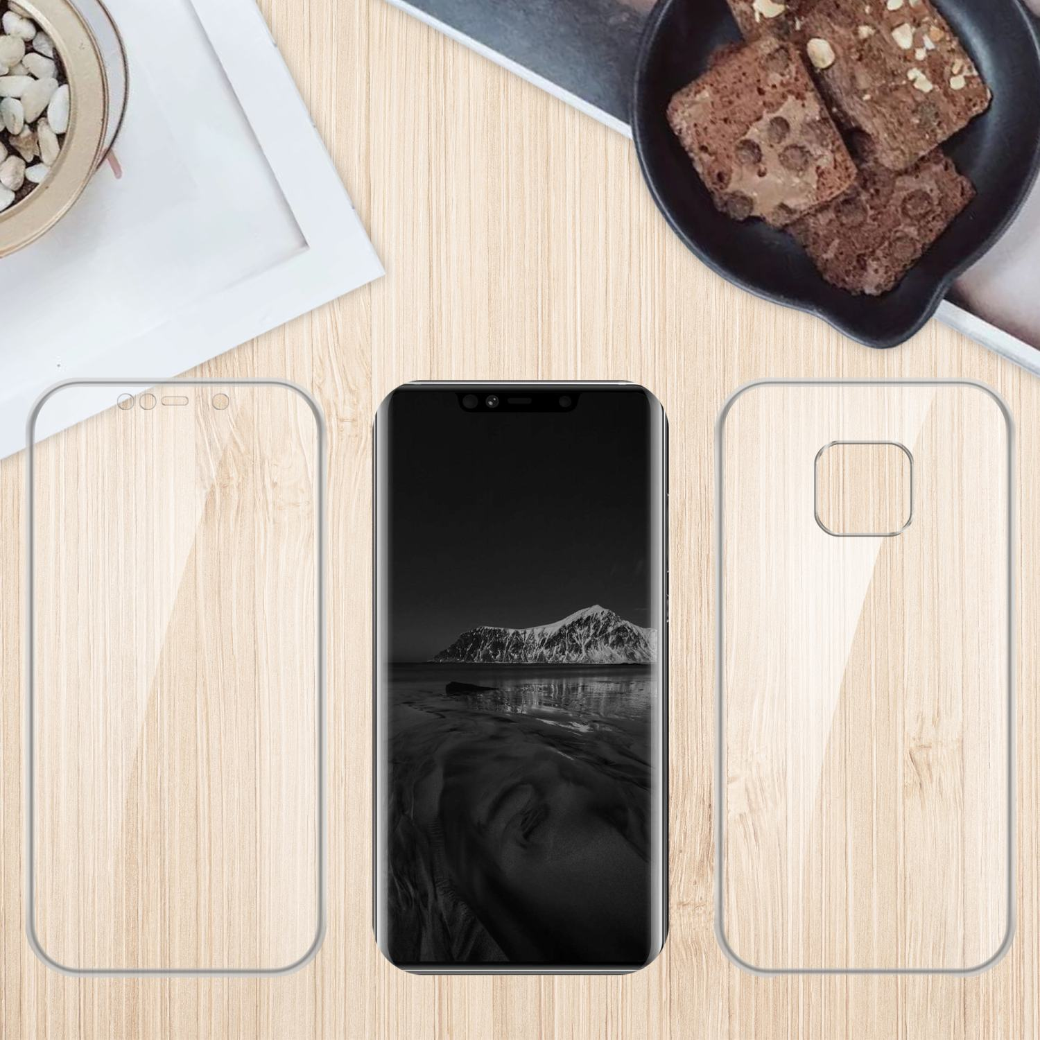 Telefono con protezione schermo e protezione fotocamera su un tavolo di legno con brownies.