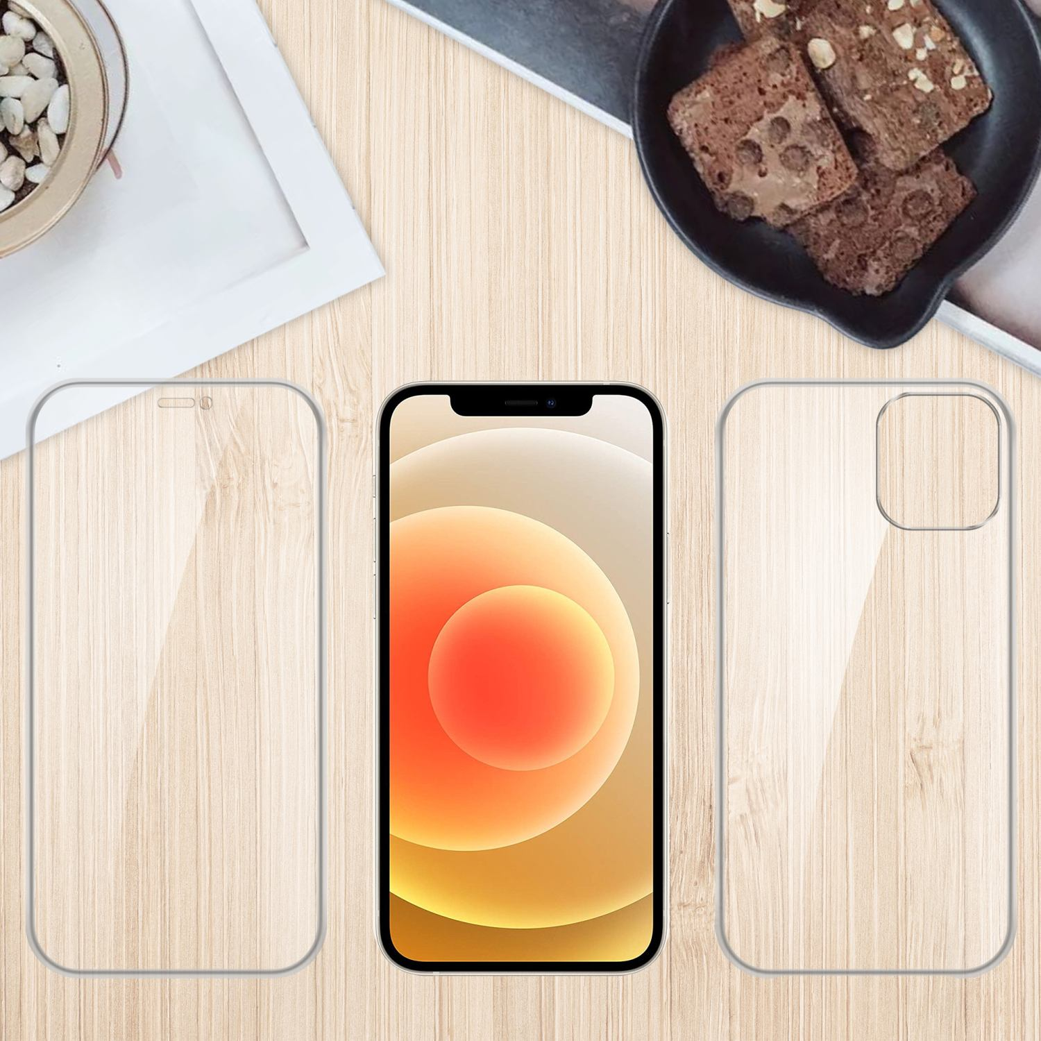 Telefono con protezione schermo e custodia su un tavolo di legno con brownies e una pianta.