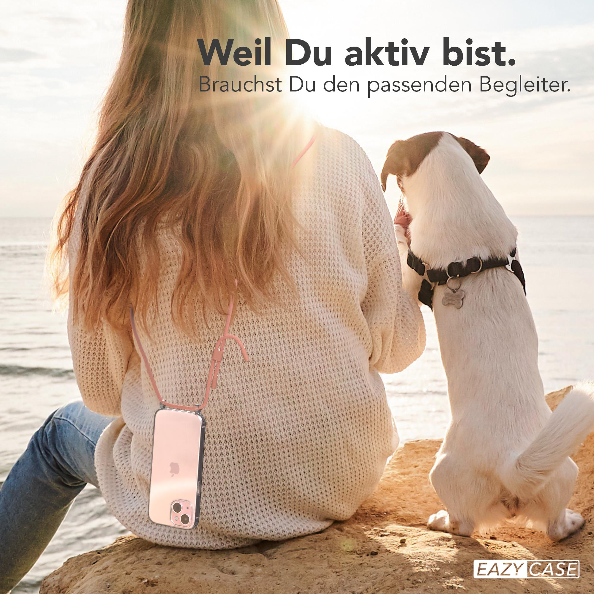 Frau mit Handyhülle an rosa Band, Hund schaut hoch.