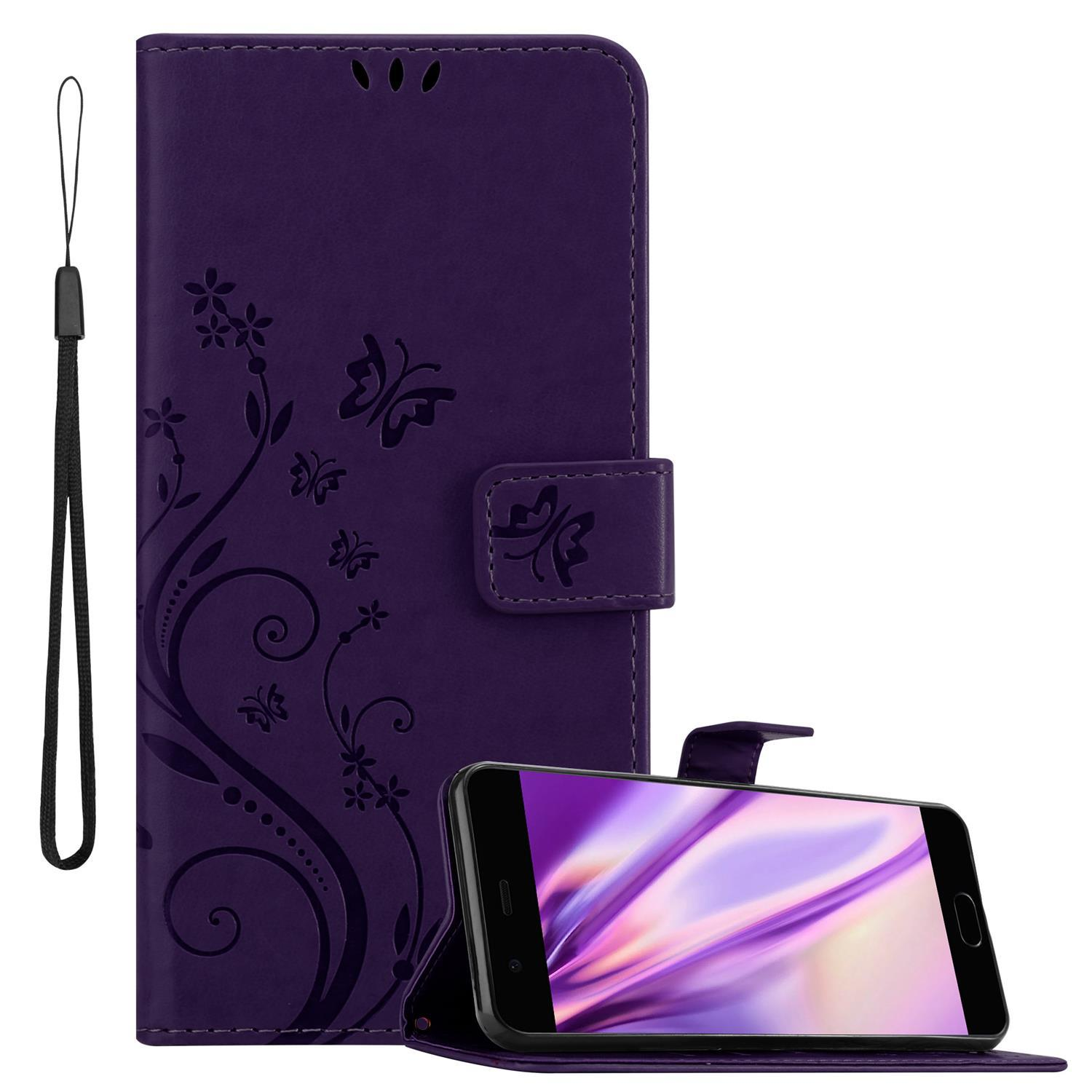 Una custodia per telefono viola con un cinturino nero e un telefono all'interno. La custodia ha un design floreale.