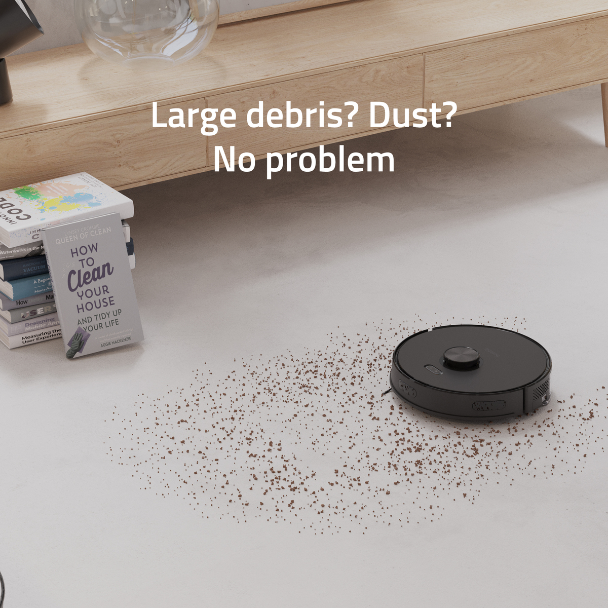 Czarny robot sprzątający na białej podłodze, ze śmieciami. Tekst: Duże śmieci? Kurz? Żaden problem.