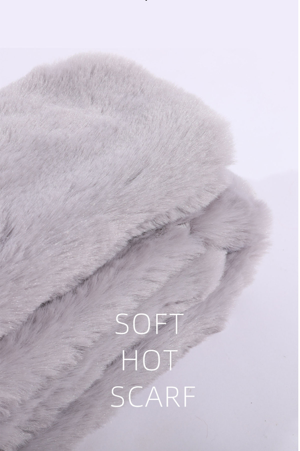 Nahaufnahme eines flauschigen grauen Schals. Das Wort 'SOFT' ist sichtbar, gefolgt von 'HOT' und 'SCARF'.