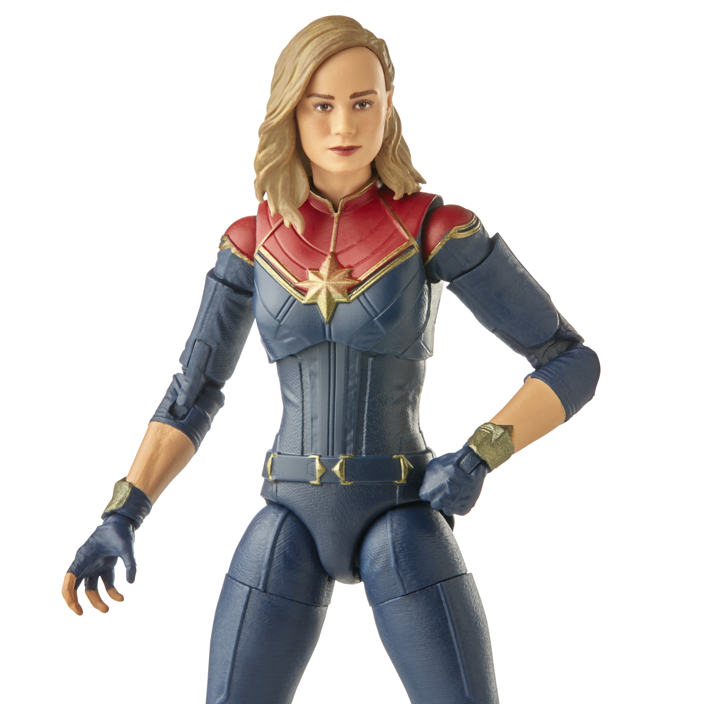 Figura de acción de Capitana Marvel con traje azul y rojo. Cabello rubio, brazos cruzados, expresión neutral.