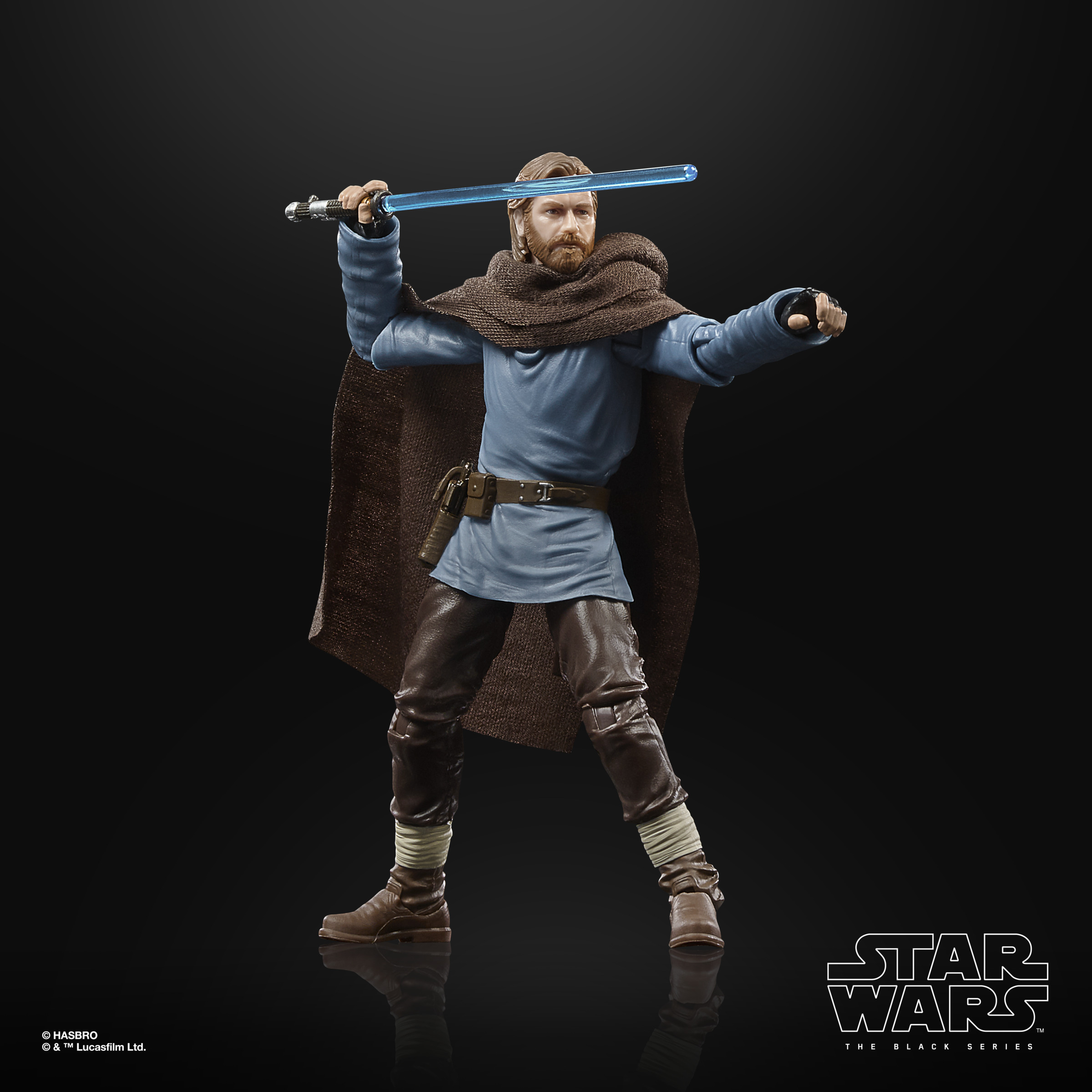 Obi-Wan Kenobi action figure holding a lightsaber, blue blade, brown cloak, black background.