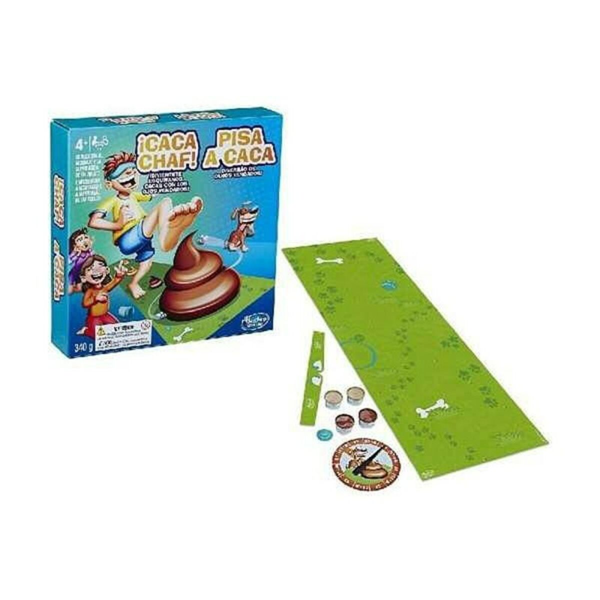 Caja del juego Caca Chaf! y componentes. Alfombra verde, caca marrón, dados y fichas.