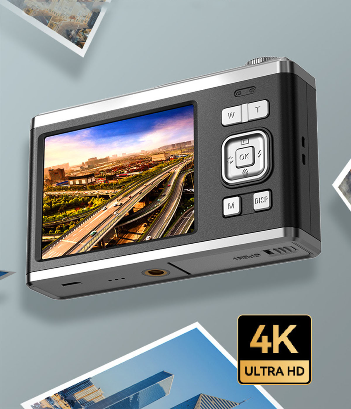 Eine schwarz-silberne Digitalkamera mit einem Display, das eine Stadtansicht zeigt.