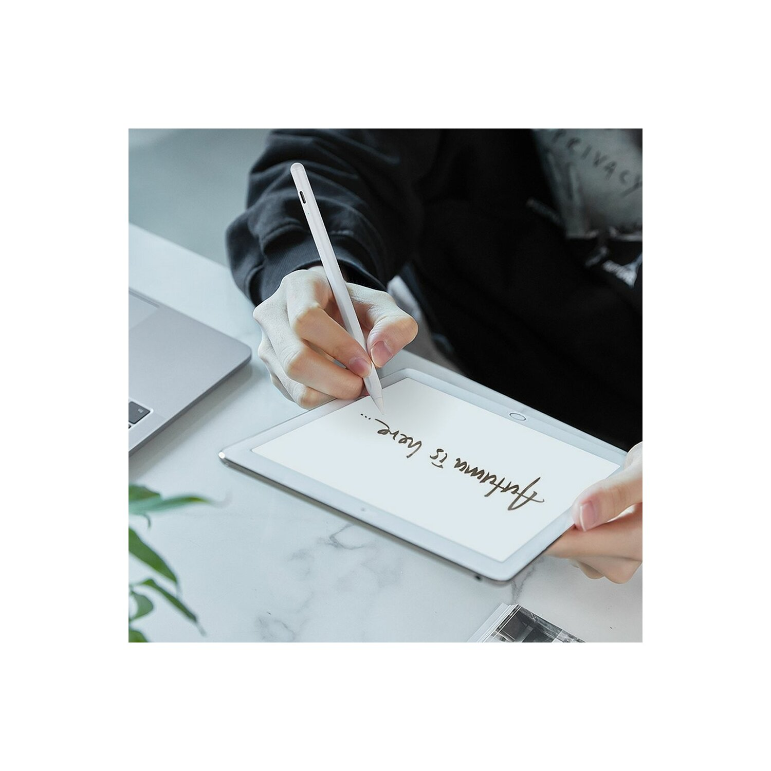 Eine Person schreibt mit einem Stift auf einem Tablet. Text sagt 'Der Herbst ist da'.