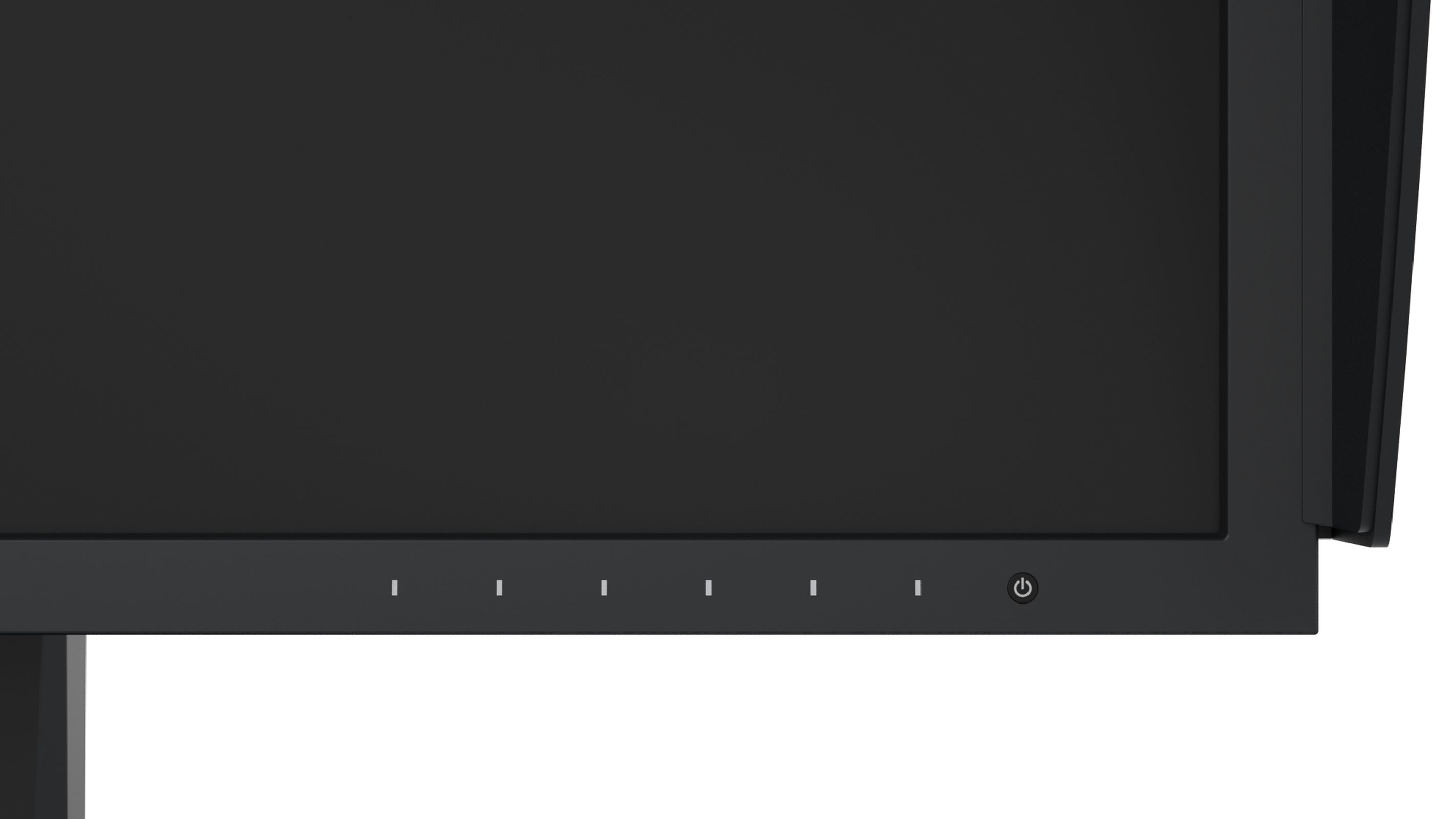 Primo piano del bordo inferiore di un monitor di computer nero. Ci sono spie e un pulsante di accensione.