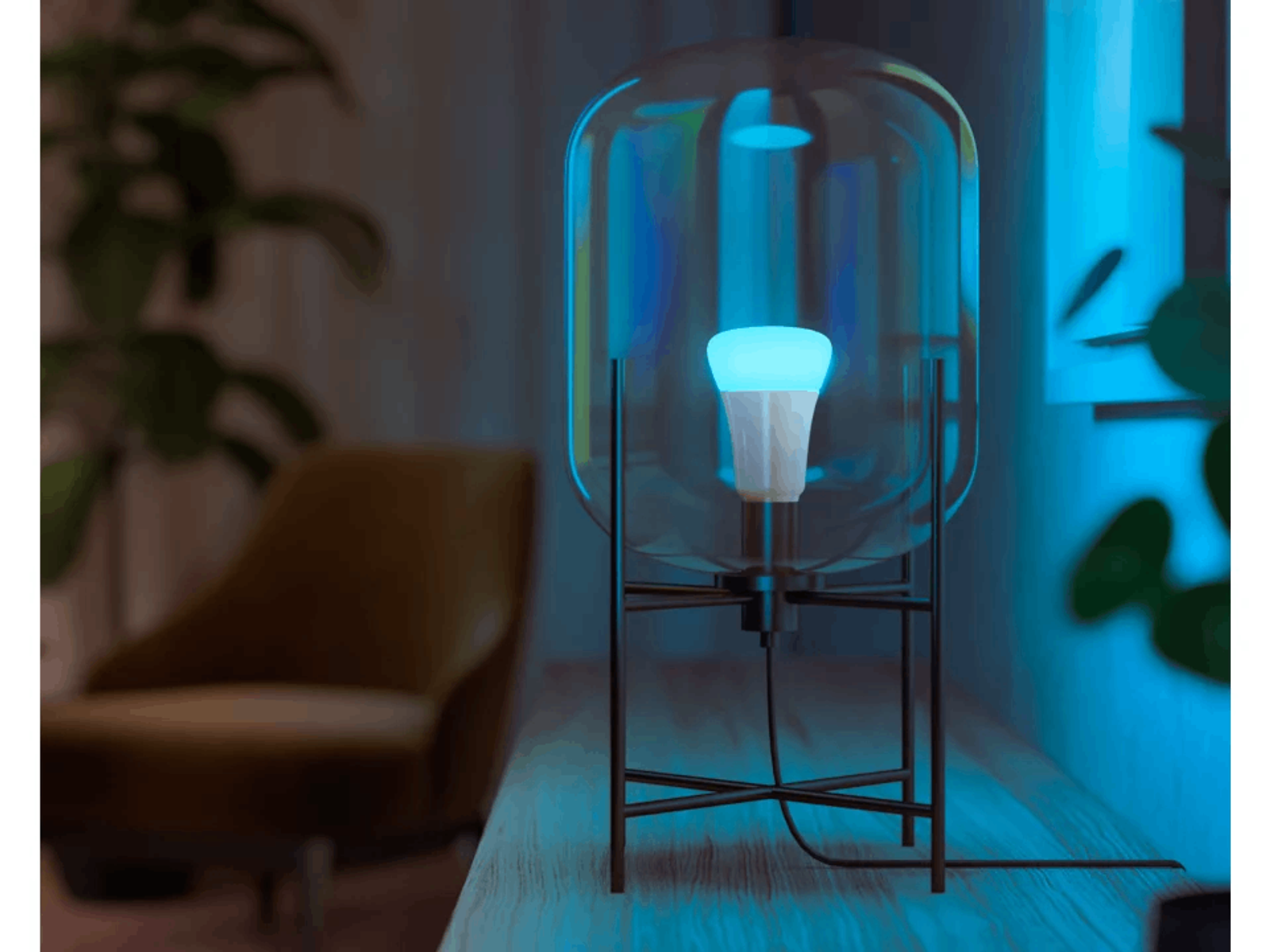 Une lampe moderne avec un abat-jour en verre et une ampoule. L'ampoule est allumée.