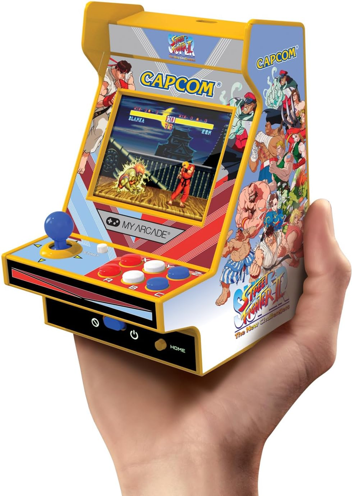 Una consola de juegos arcade en miniatura en una mano. La pantalla muestra un juego de lucha.
