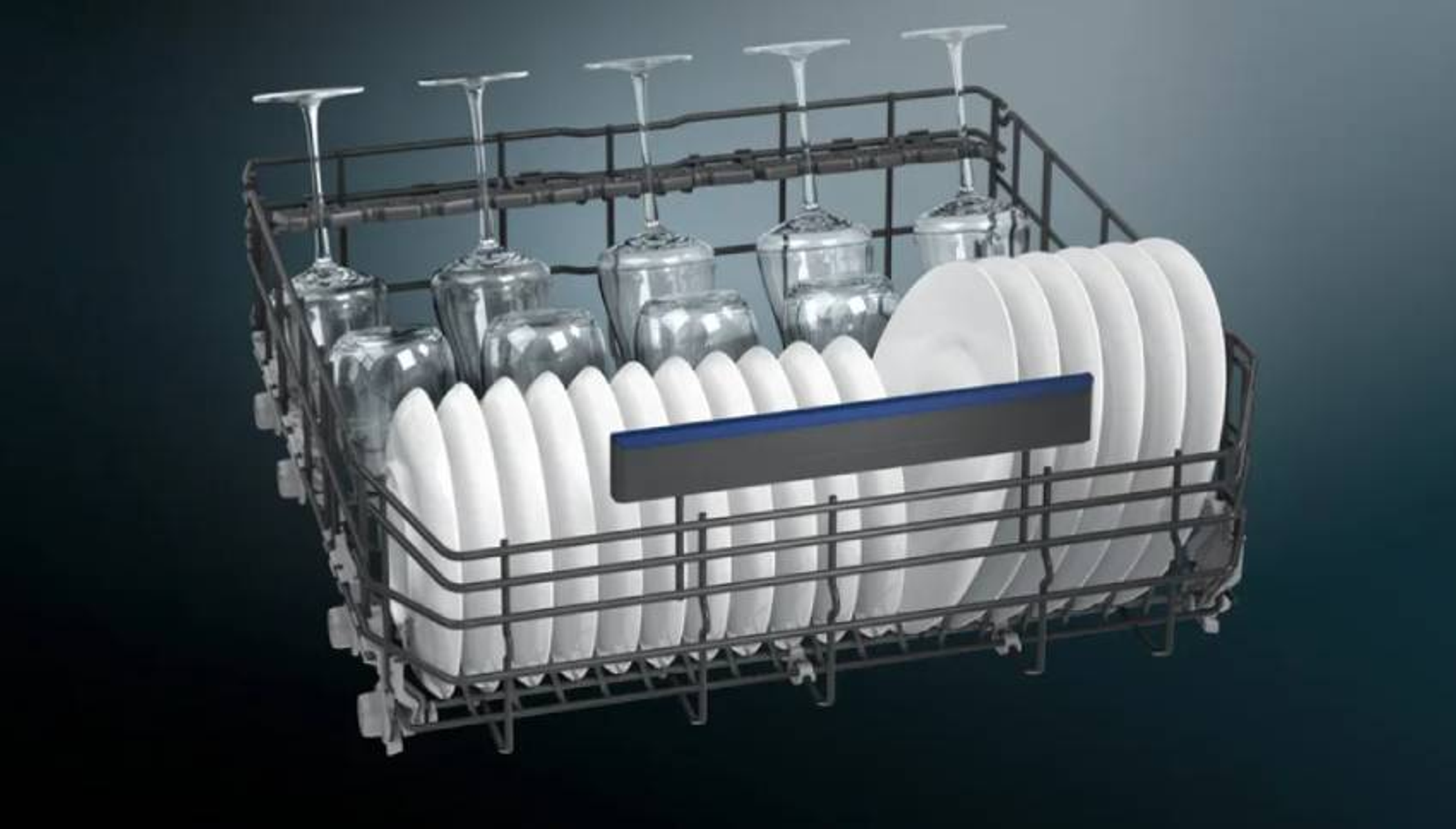 Wnętrze zmywarki pokazujące ułożone talerze i szklanki.