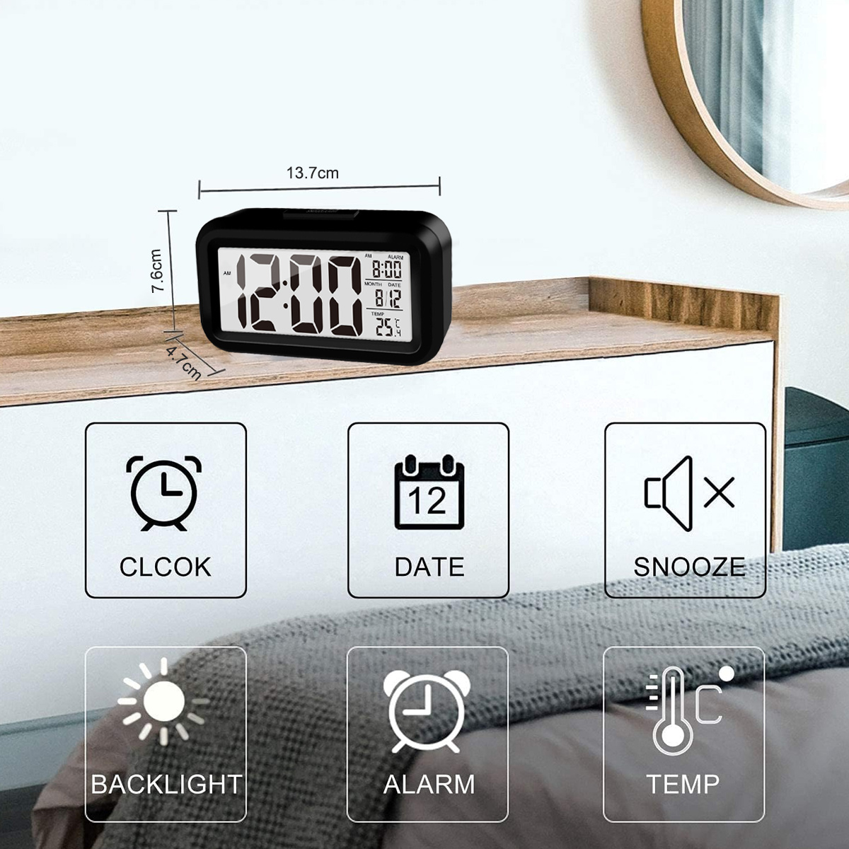 Eine schwarze Digitaluhr mit Anzeige von Zeit, Datum, Alarm, Temperatur und Schlummer-Symbolen.
