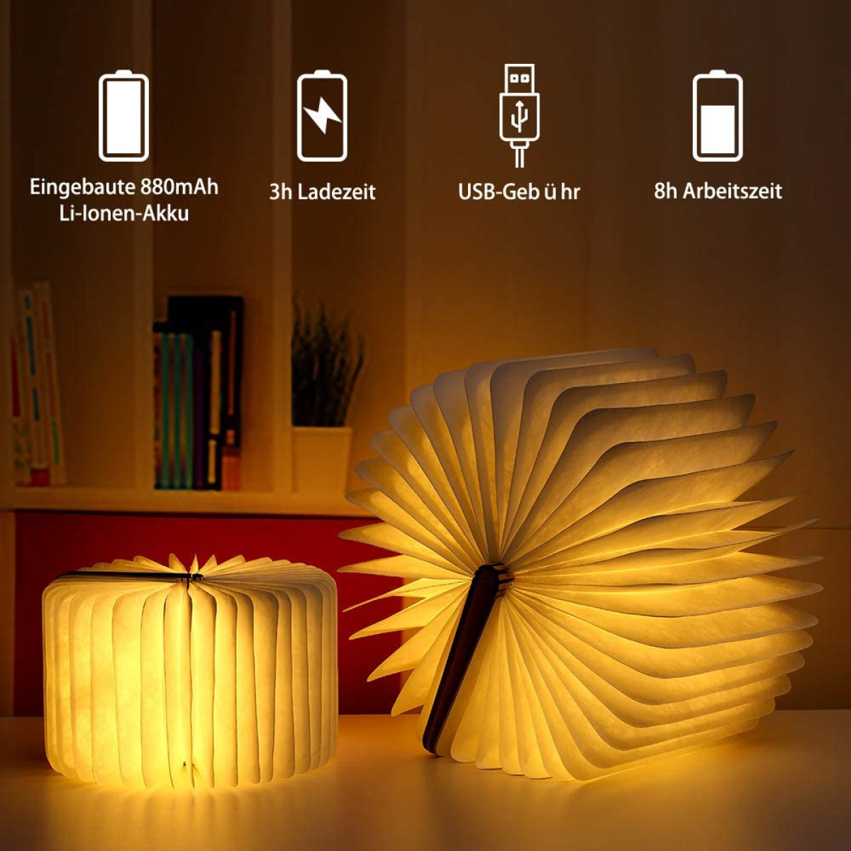 Eine dekorative, buchförmige Lampe, geöffnet, die warmes Licht ausstrahlt. Daneben liegt eine geschlossene Lampe.