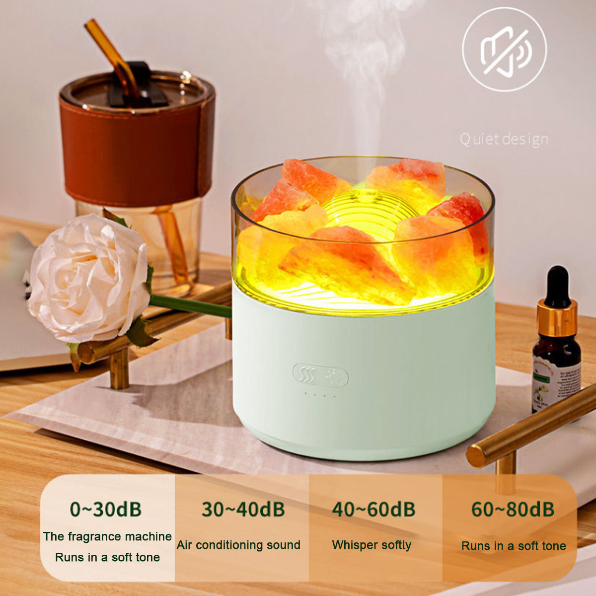 Aromadiffusor mit Rose und Ölflasche. Der Diffusor hat Wasser und orangefarbene Kristalle.