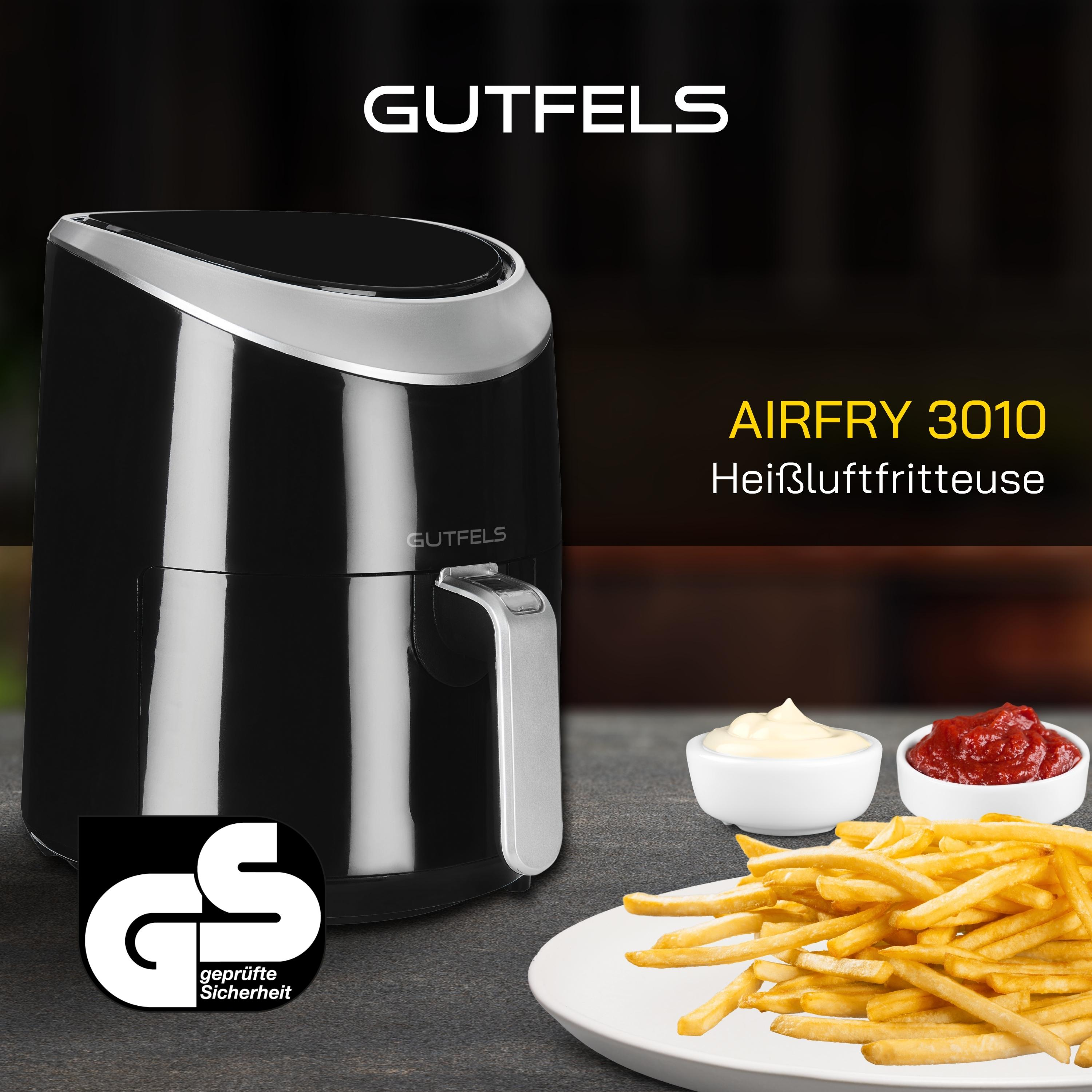 Schwarze Heißluftfritteuse, Pommes und Saucen auf einem Tisch. Gutefels-Markenname sichtbar.