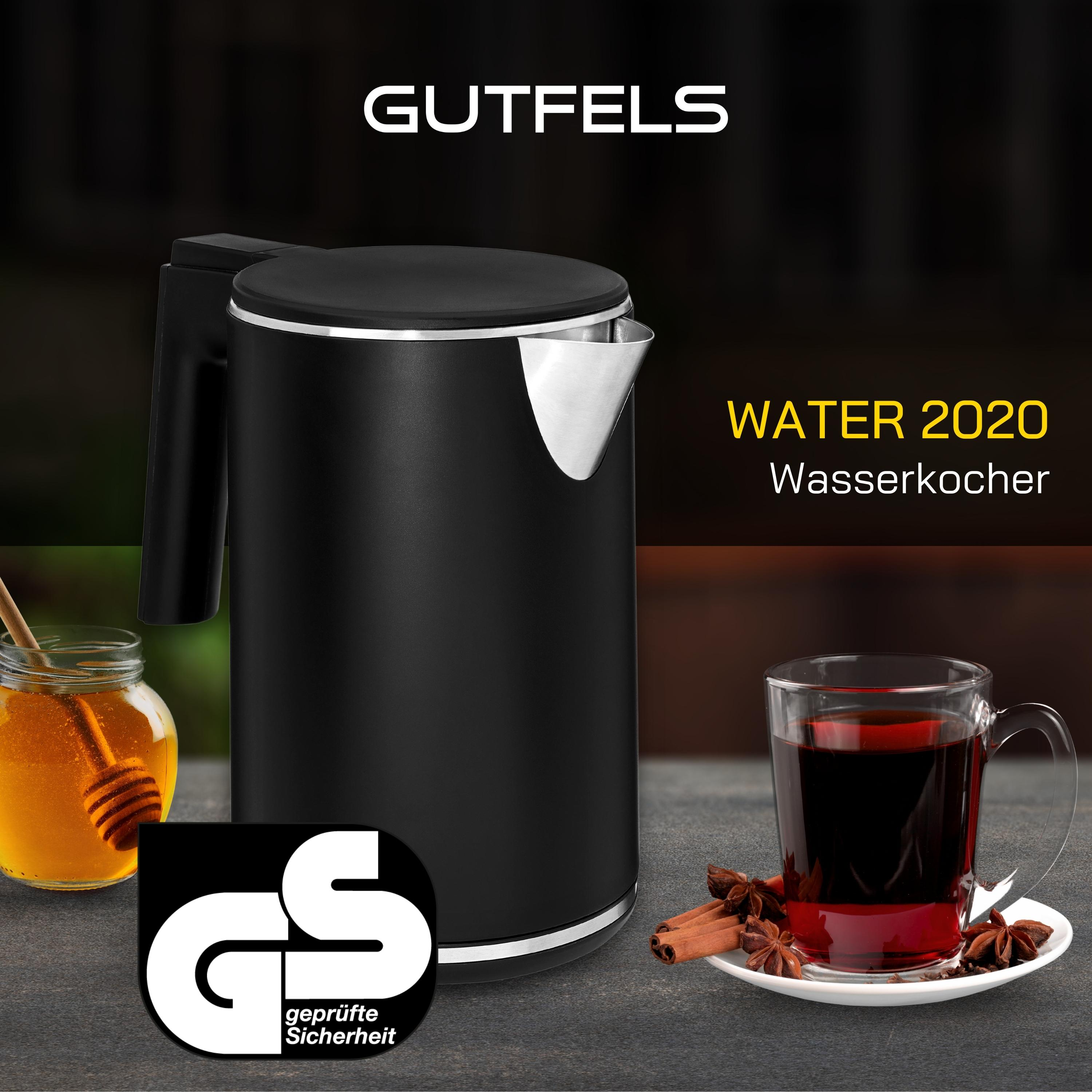 Ein schwarzer Wasserkocher und ein Glas mit einem Getränk. Es gibt auch ein Glas Honig und Zimt.