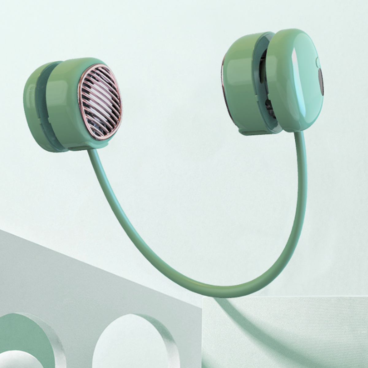Grüner Nackenventilator auf einem Sockel. Der Ventilator hat zwei kreisförmige Teile, die durch ein gebogenes Band verbunden sind.