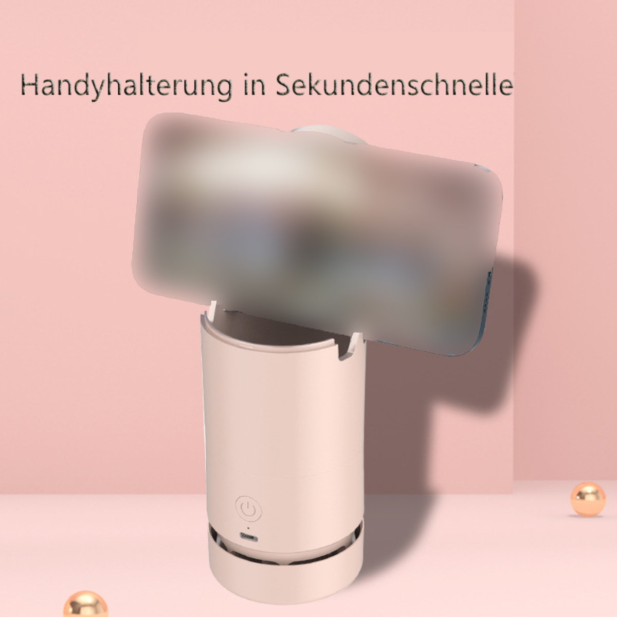 Dispositivo rosa y blanco con teléfono borroso adjunto, orbes dorados en el fondo. Texto: 'Handyhalterung in Sekundenschnelle'.