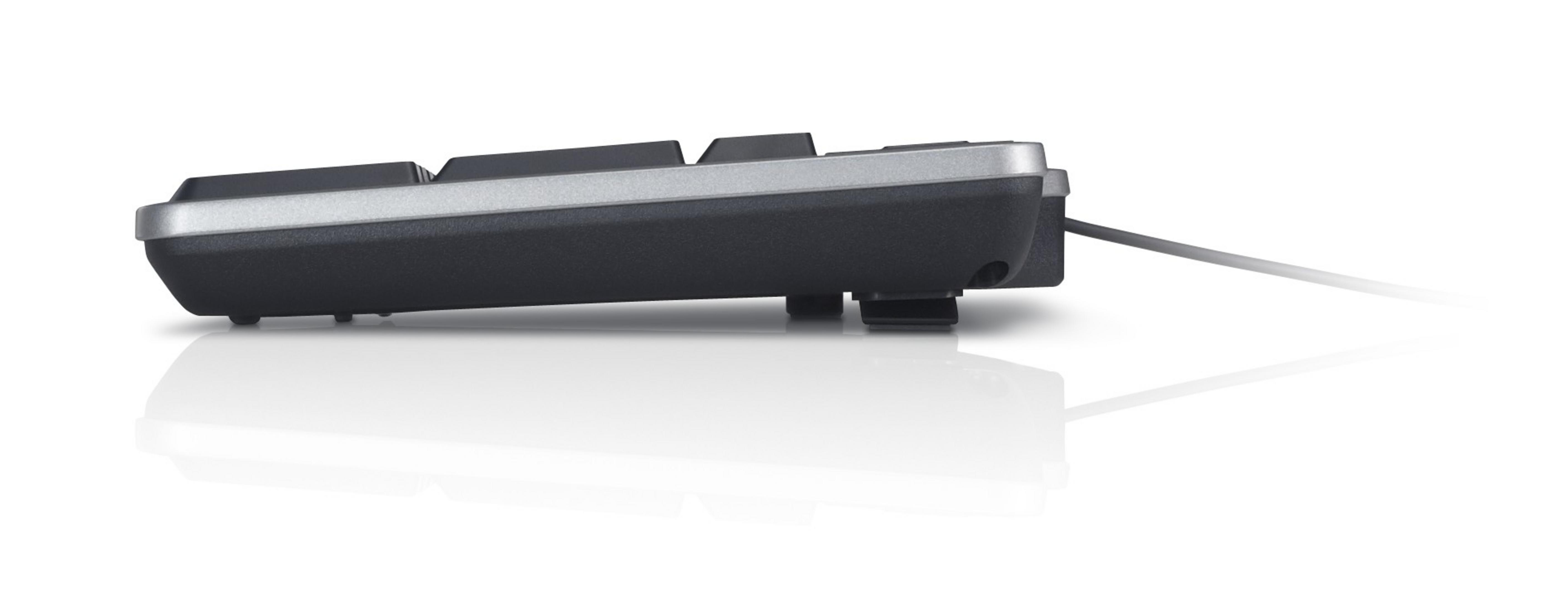 Widok z boku czarnej klawiatury Dell ze srebrną obwódką. Klawiatura leży na białej powierzchni, rzucając odbicie.