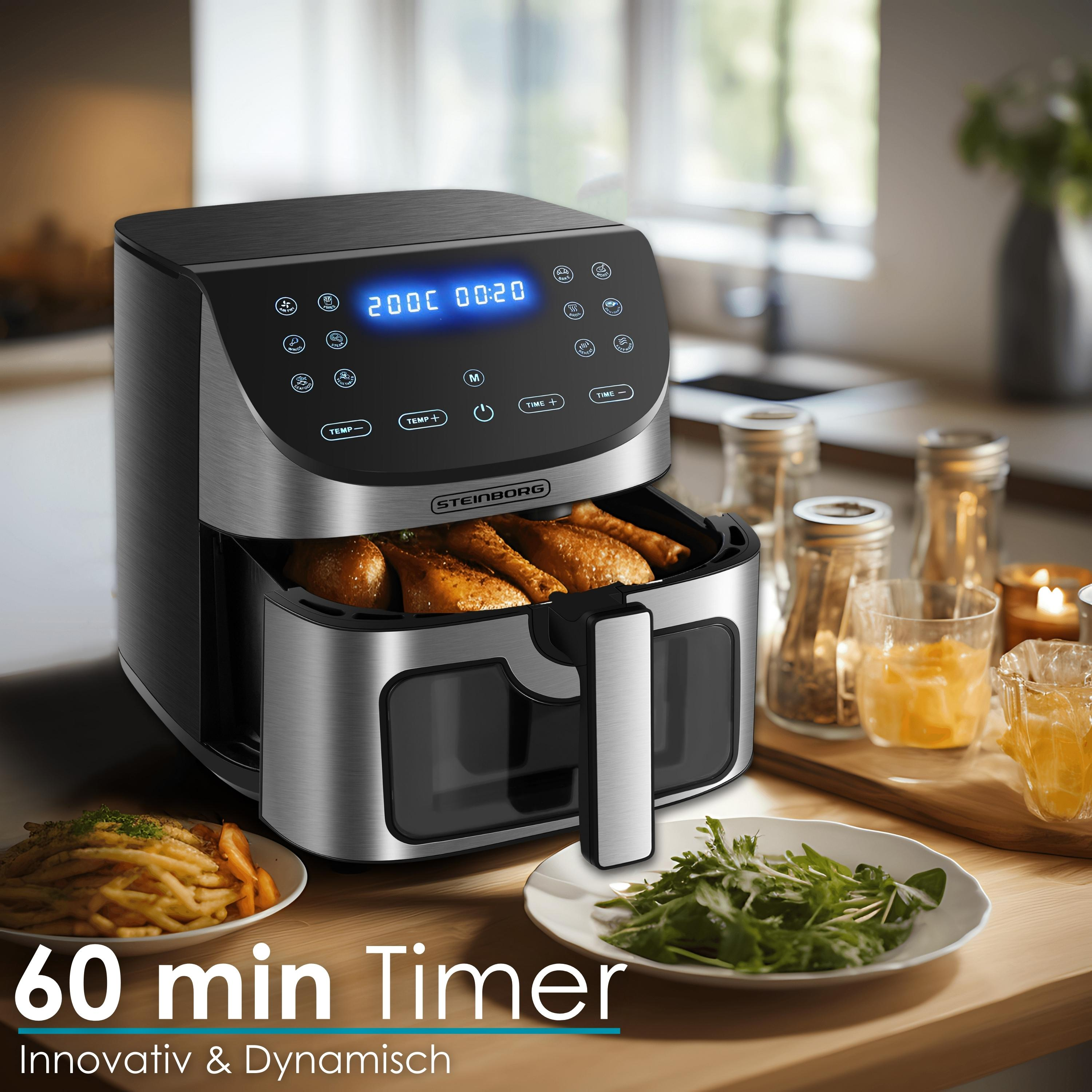 Une friteuse à air avec du poulet frit, des frites et des légumes verts. Une minuterie affiche 20 minutes.