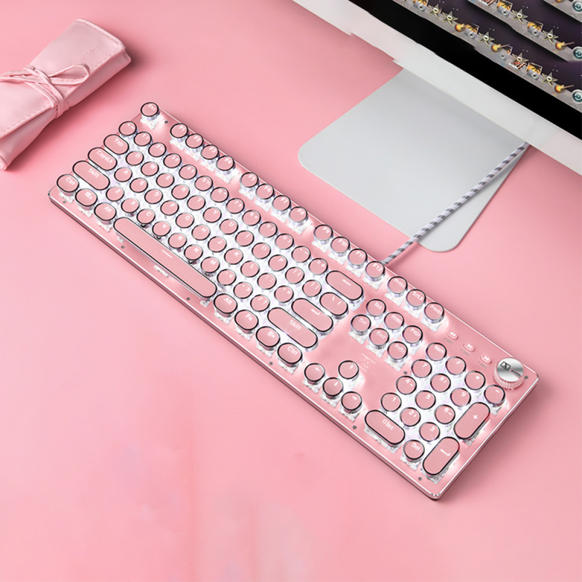 Rosa Tastatur mit runden Tasten und beleuchteten Lichtern.