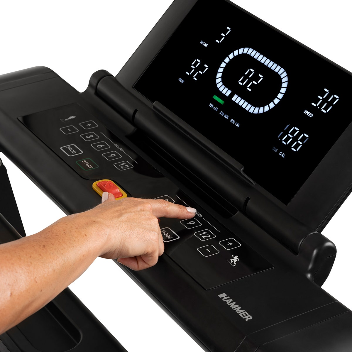 Eine Hand drückt eine Taste auf einem schwarzen Laufband-Bedienfeld mit einem digitalen Bildschirm.