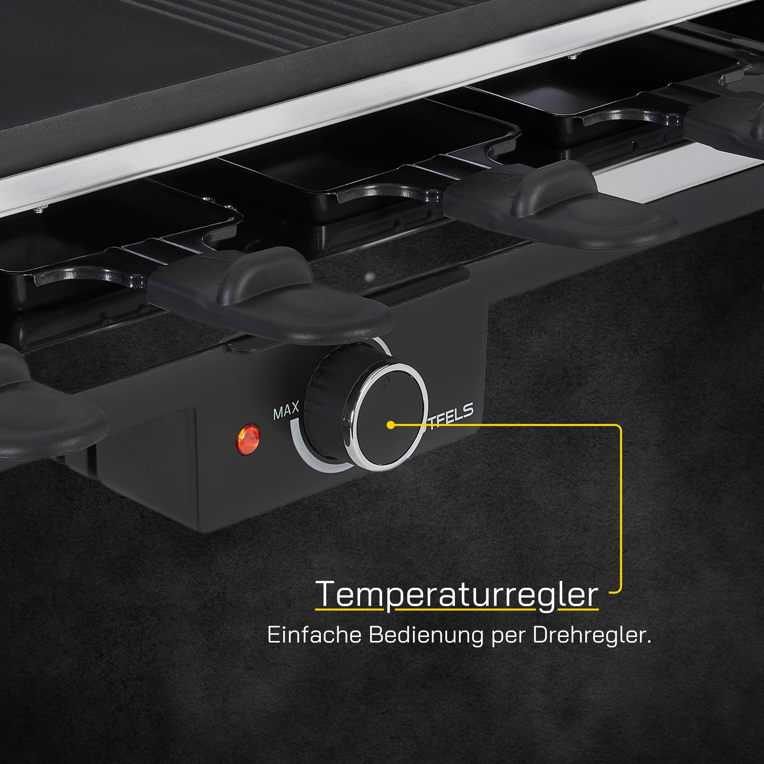 Ein Raclette-Grill mit Temperaturregler und schwarzen Pfannen, auf schwarzer Oberfläche.