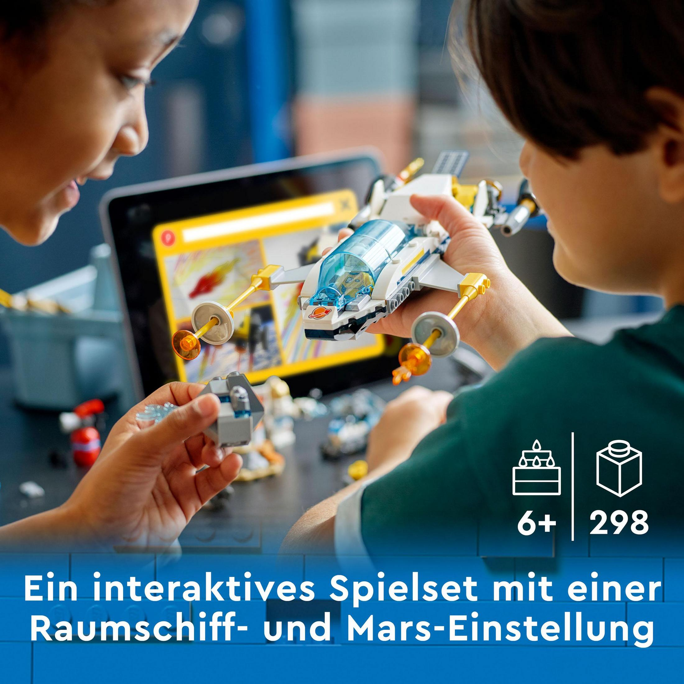 Zwei Kinder bauen ein Lego-Raumschiffmodell. Das Modell ist weiß, blau und gelb. Im Hintergrund ein Tablet.