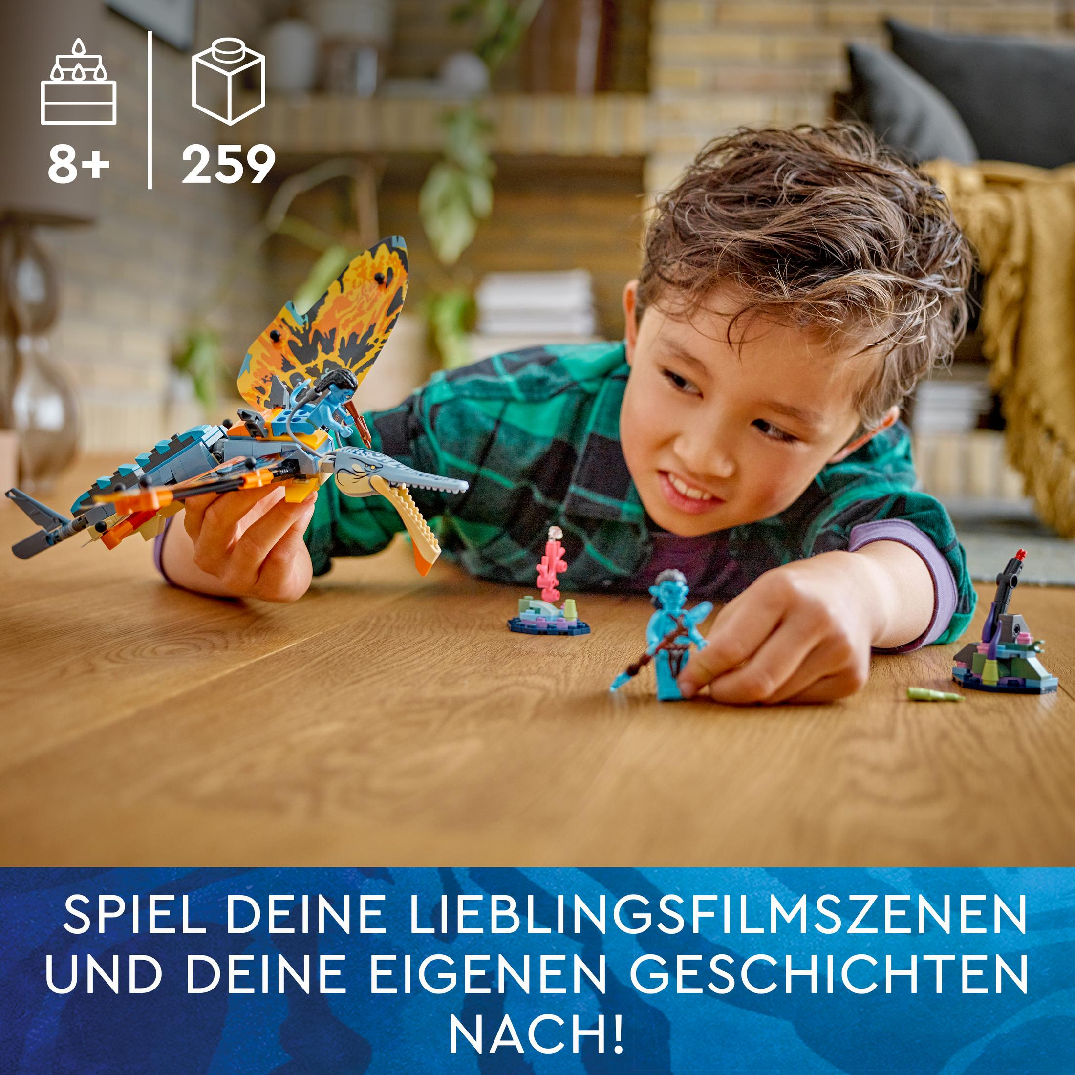 Un ragazzo gioca con i set Lego Avatar, con un tavolo di legno e testo in tedesco.