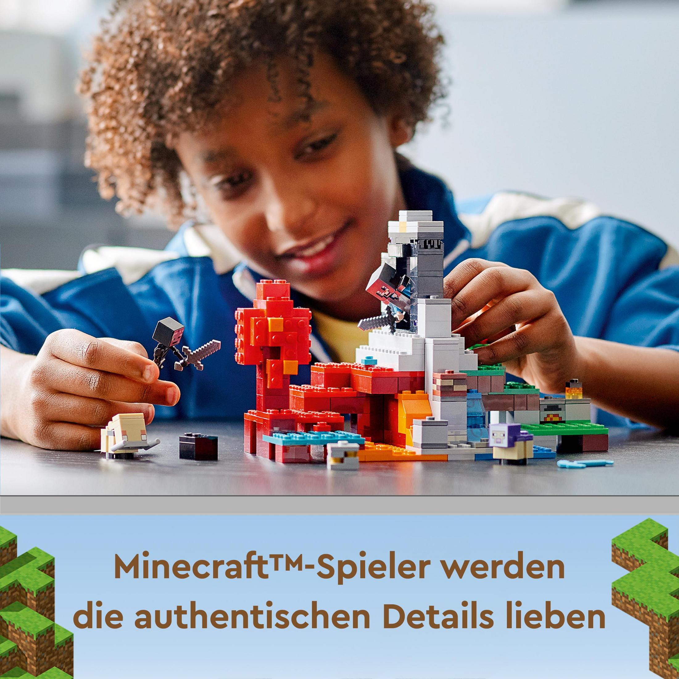 Ein Junge spielt mit Minecraft Lego-Blöcken, baut eine farbenfrohe Struktur und lächelt.