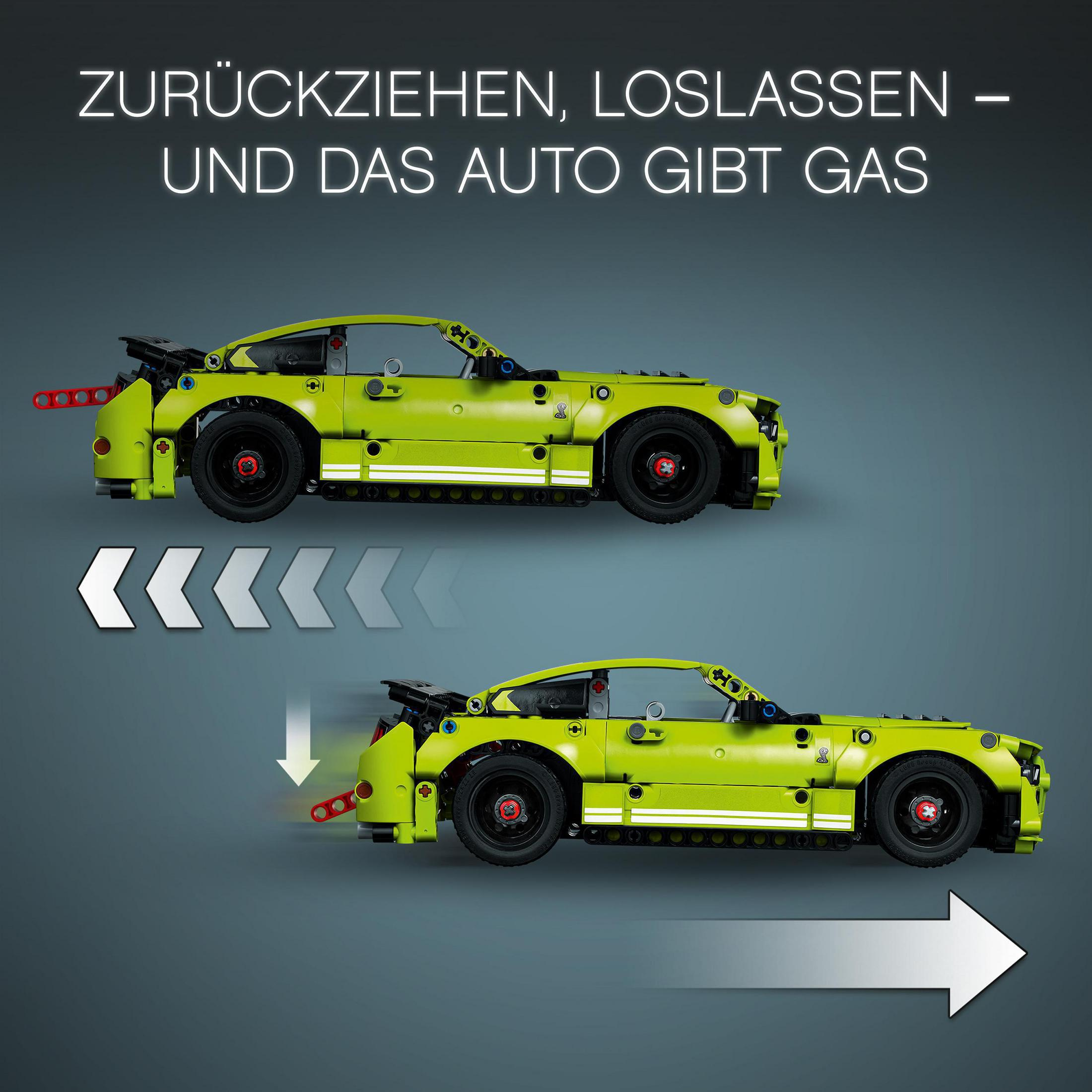 Zwei Spielzeugautos, eines in Bewegung, eines stationär, mit Text 'ZURÜCKZIEHEN, LOSLASSEN' und Pfeil.