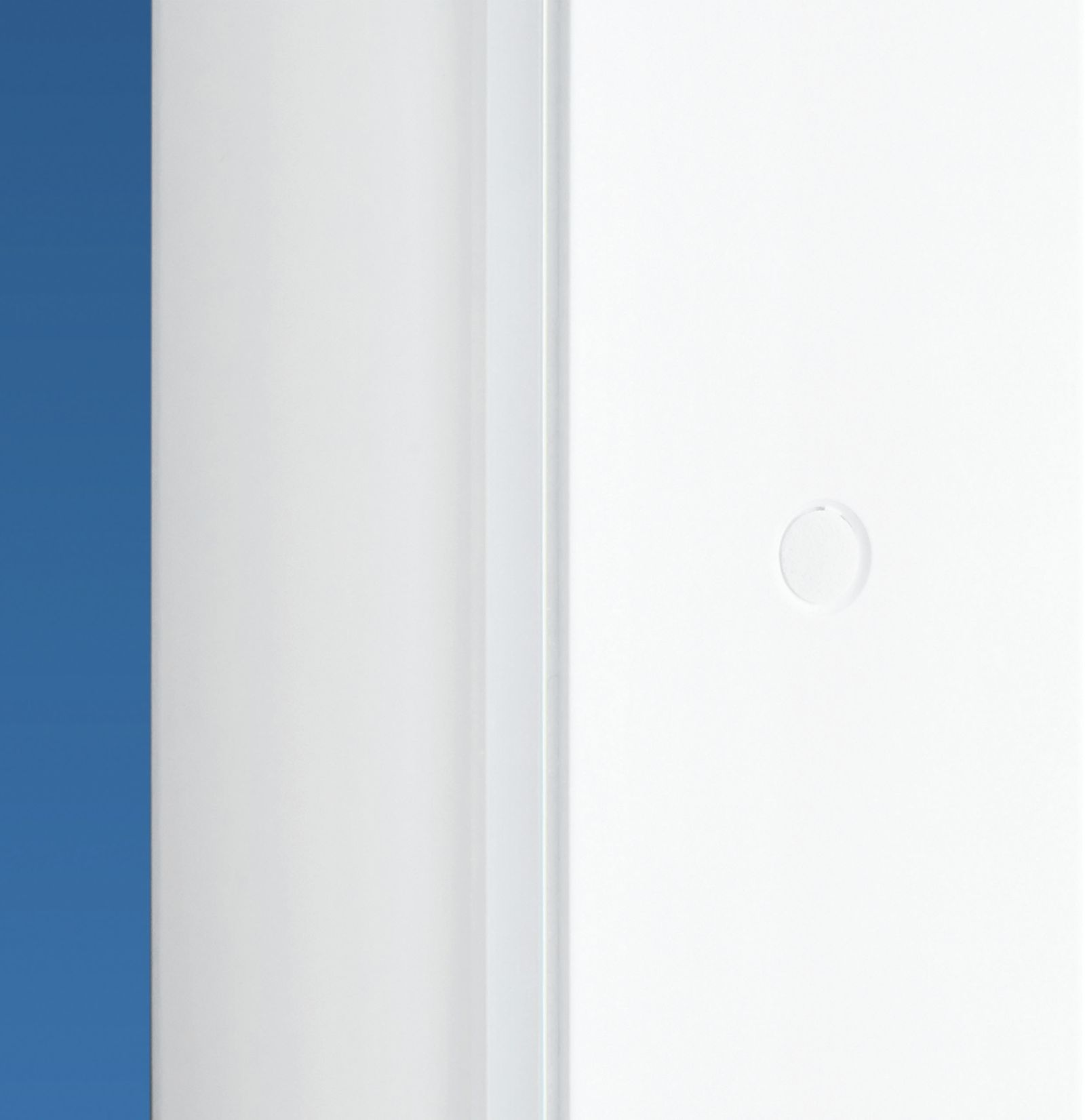 Zbliżenie białych, błyszczących drzwi z małym okrągłym uchwytem na niebieskim tle.