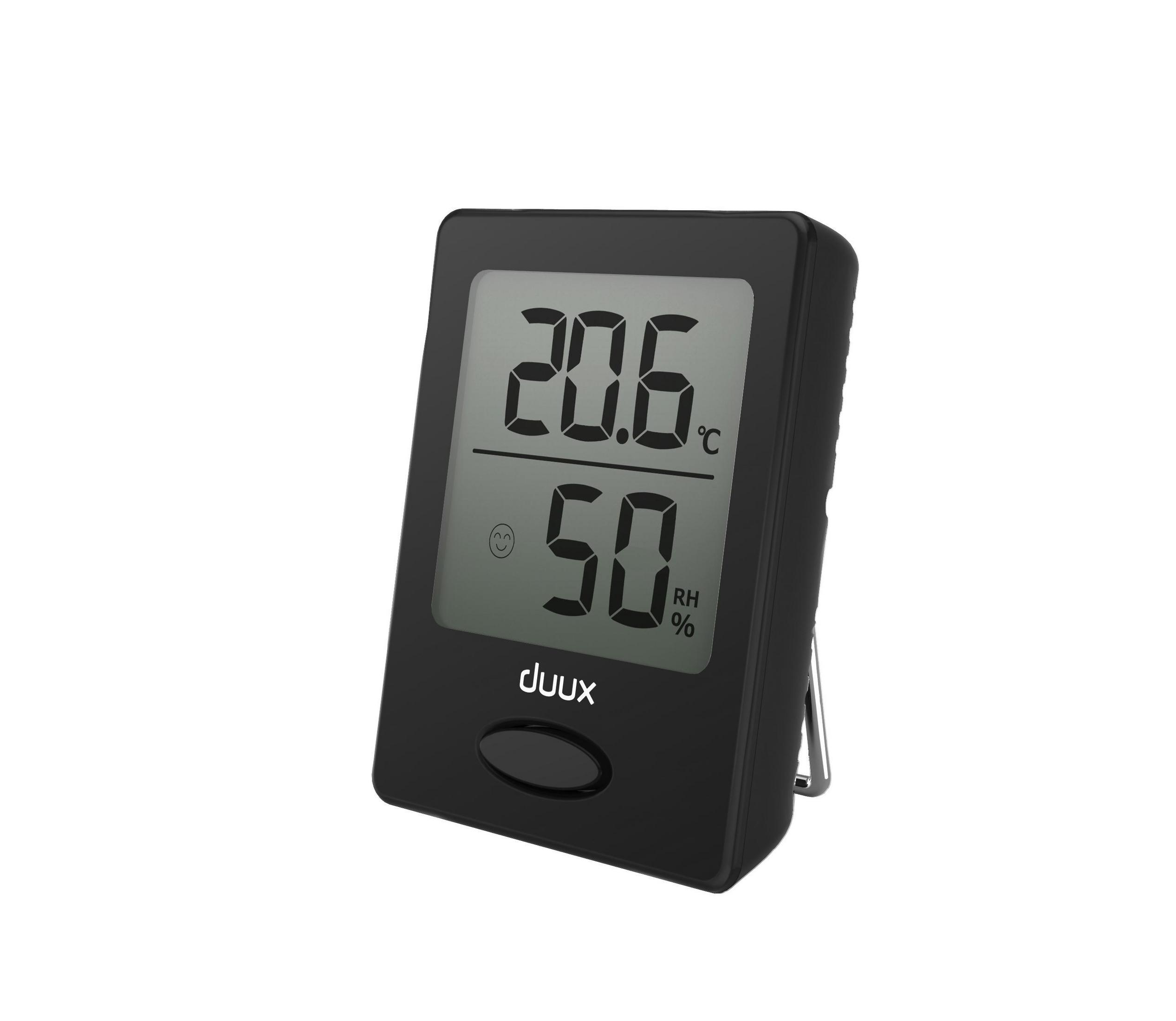 Termómetro digital negro mostrando niveles de temperatura y humedad, sobre una superficie blanca.